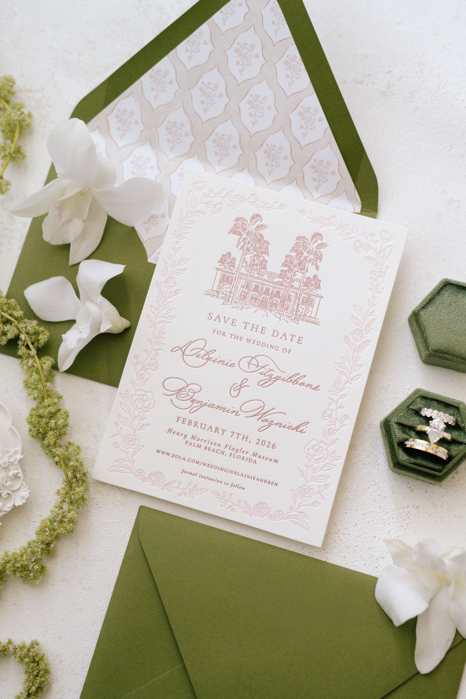 Wedding save the date card featuring pink castle illustration and green envelope with white flowers.