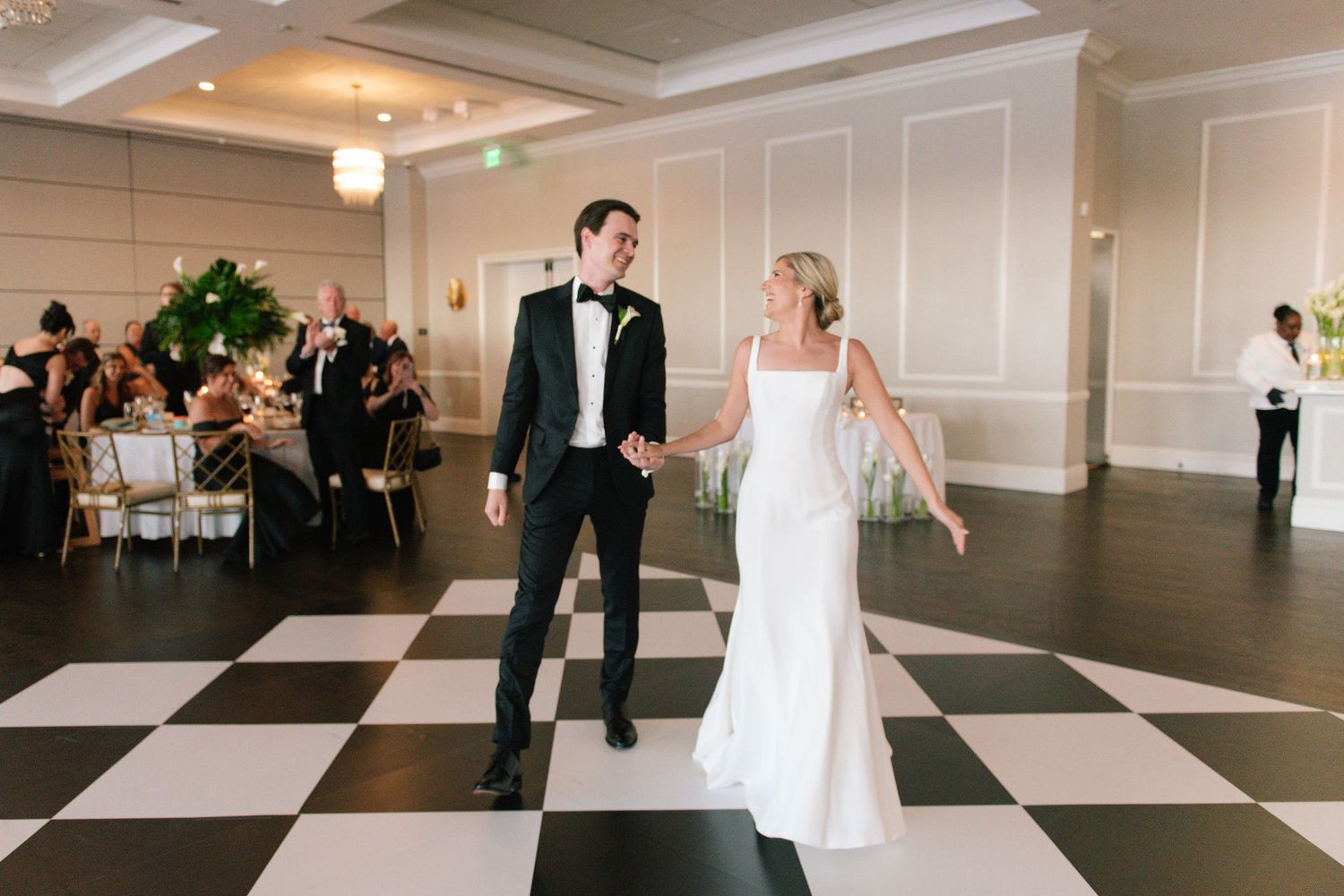 Black and white checkered dance floor at an elegant wedding reception.