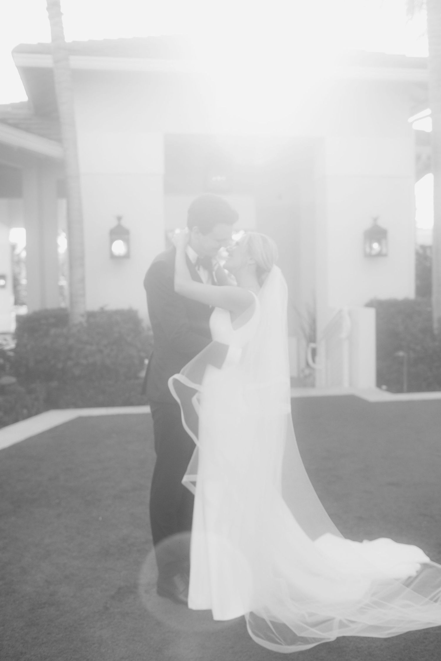 Dreamy black and white wedding photos captured on a misty outdoor lawn.