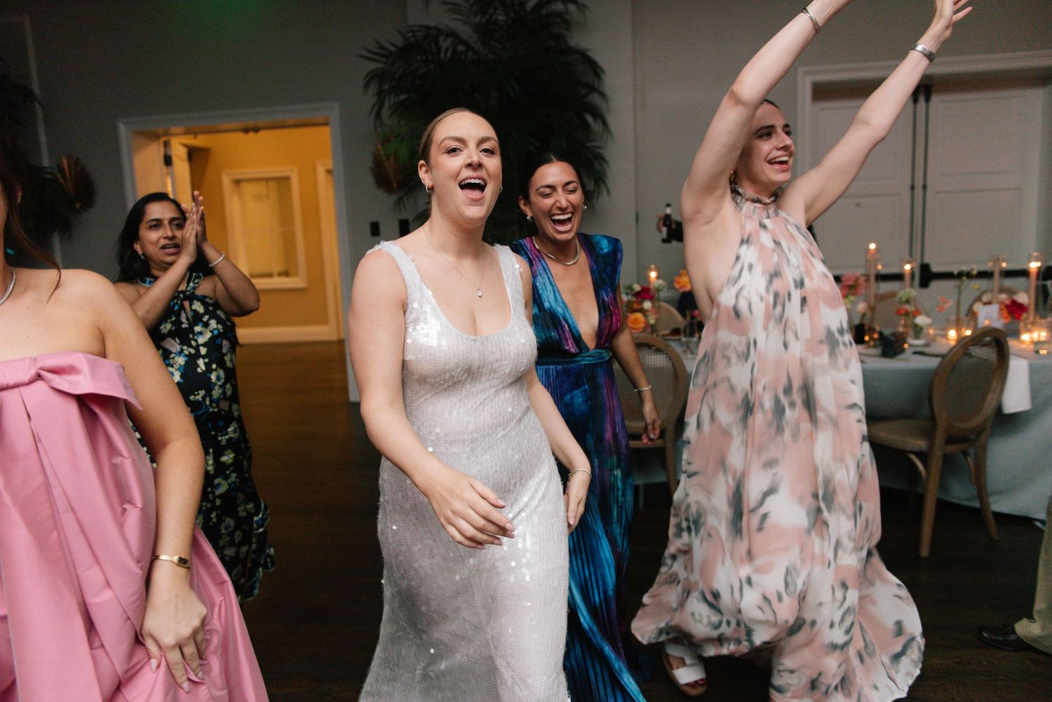 Wedding celebration with guests dancing and enjoying themselves on the dance floor.