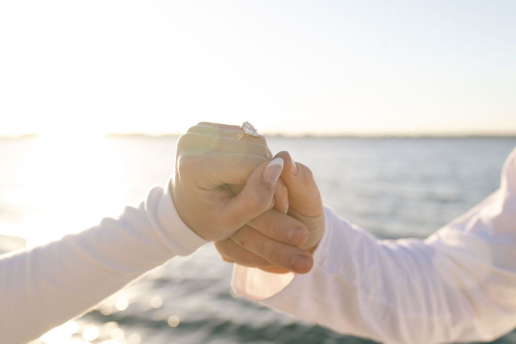 Couple enjoying peaceful moment on boat deck with ocean horizon view.