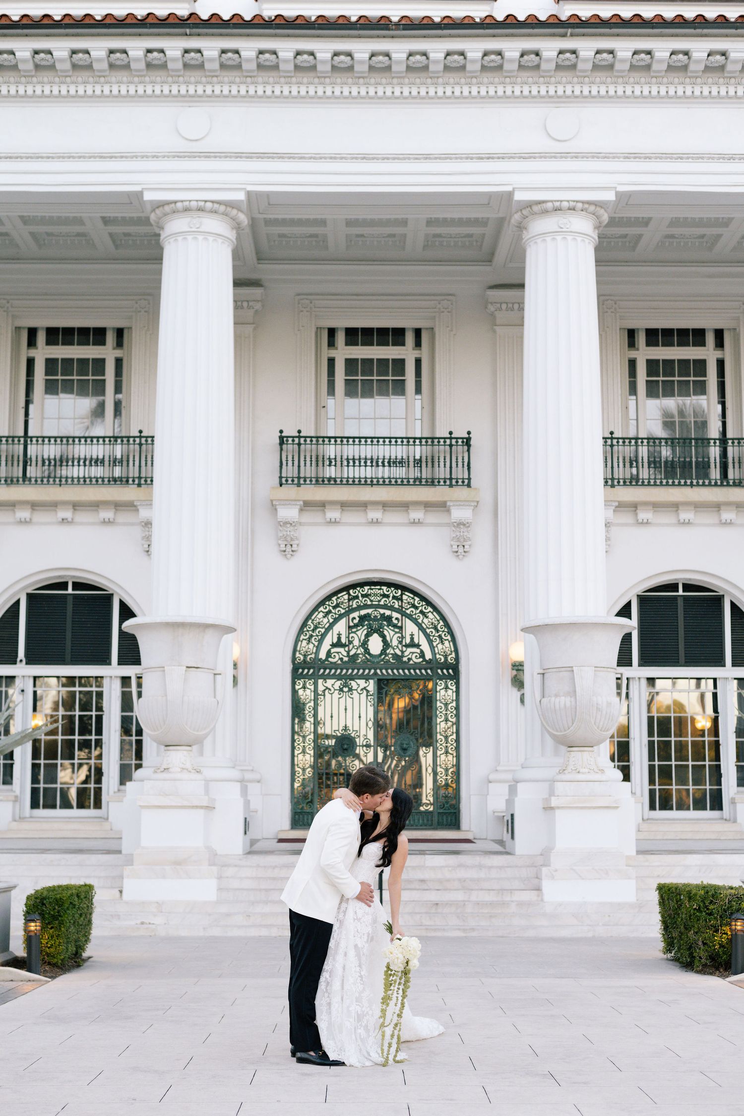 Panoramic wedding photography sequence showing couple against grand white colonial architecture.