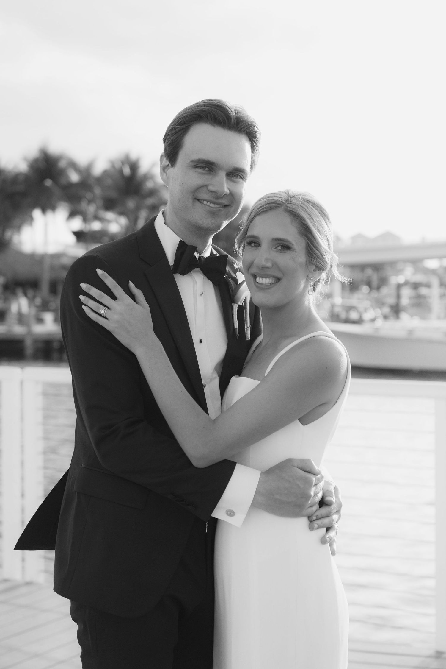 Joyful wedding portraits captured against a waterfront backdrop.