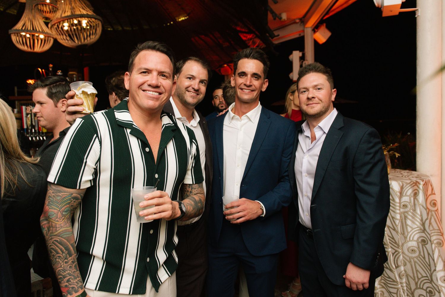 Group of well-dressed guests celebrating at an elegant evening event.