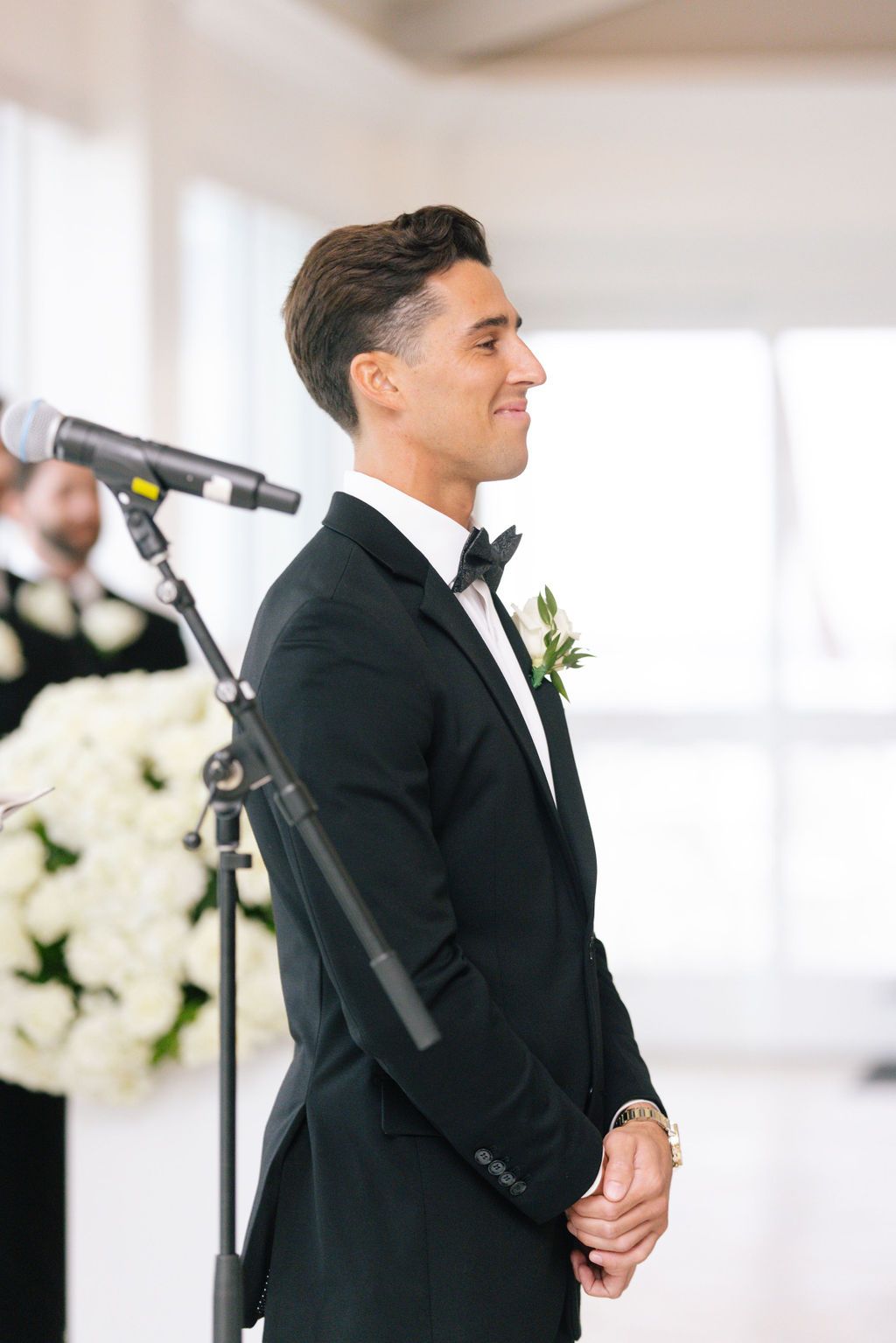 Wedding ceremony participants in formal attire standing at the altar.