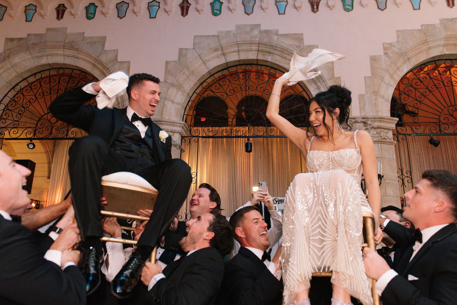 Elegant wedding reception venue with stone archways and decorative lighting.