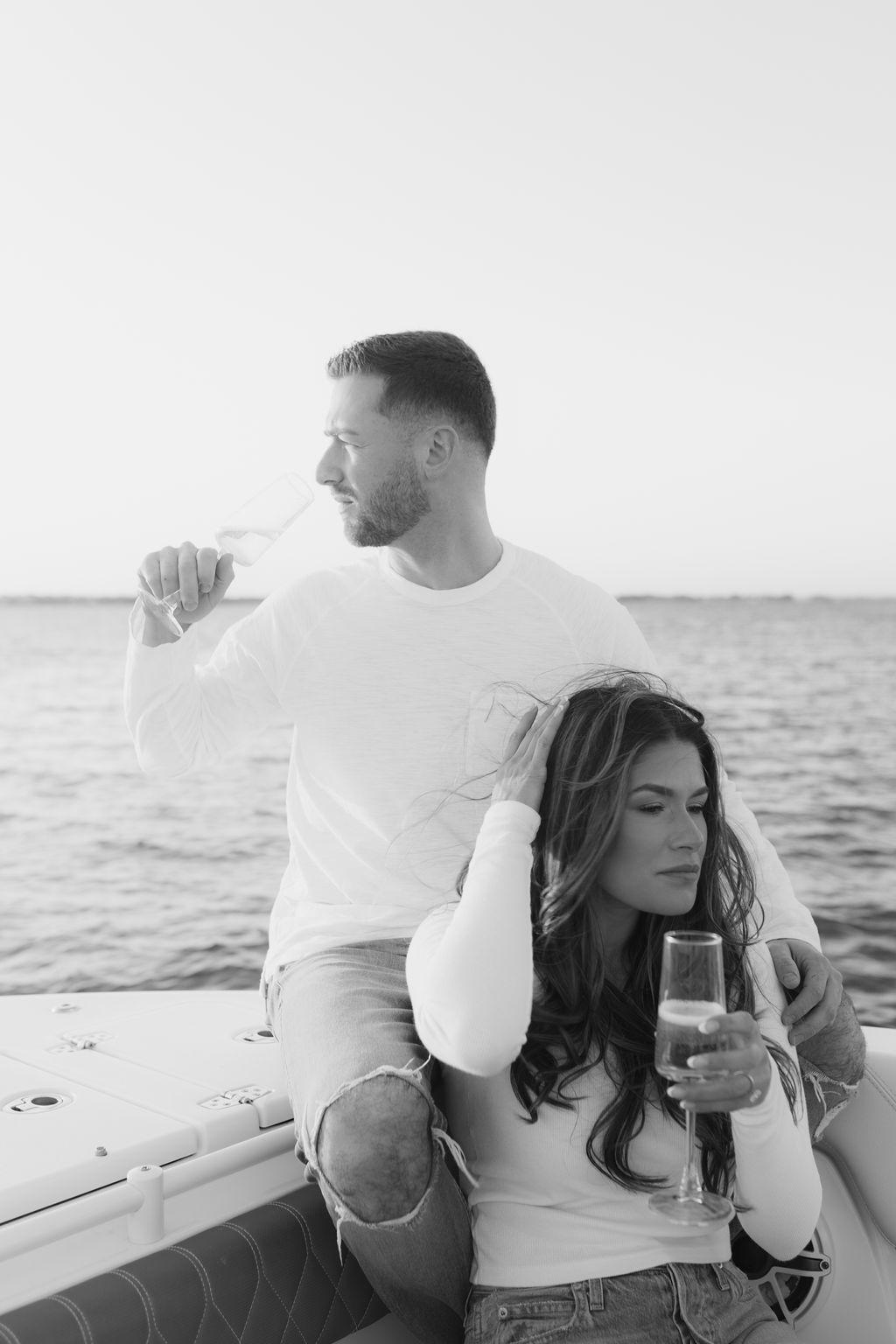 Couple sharing intimate moments on a boat during a sunset cruise.