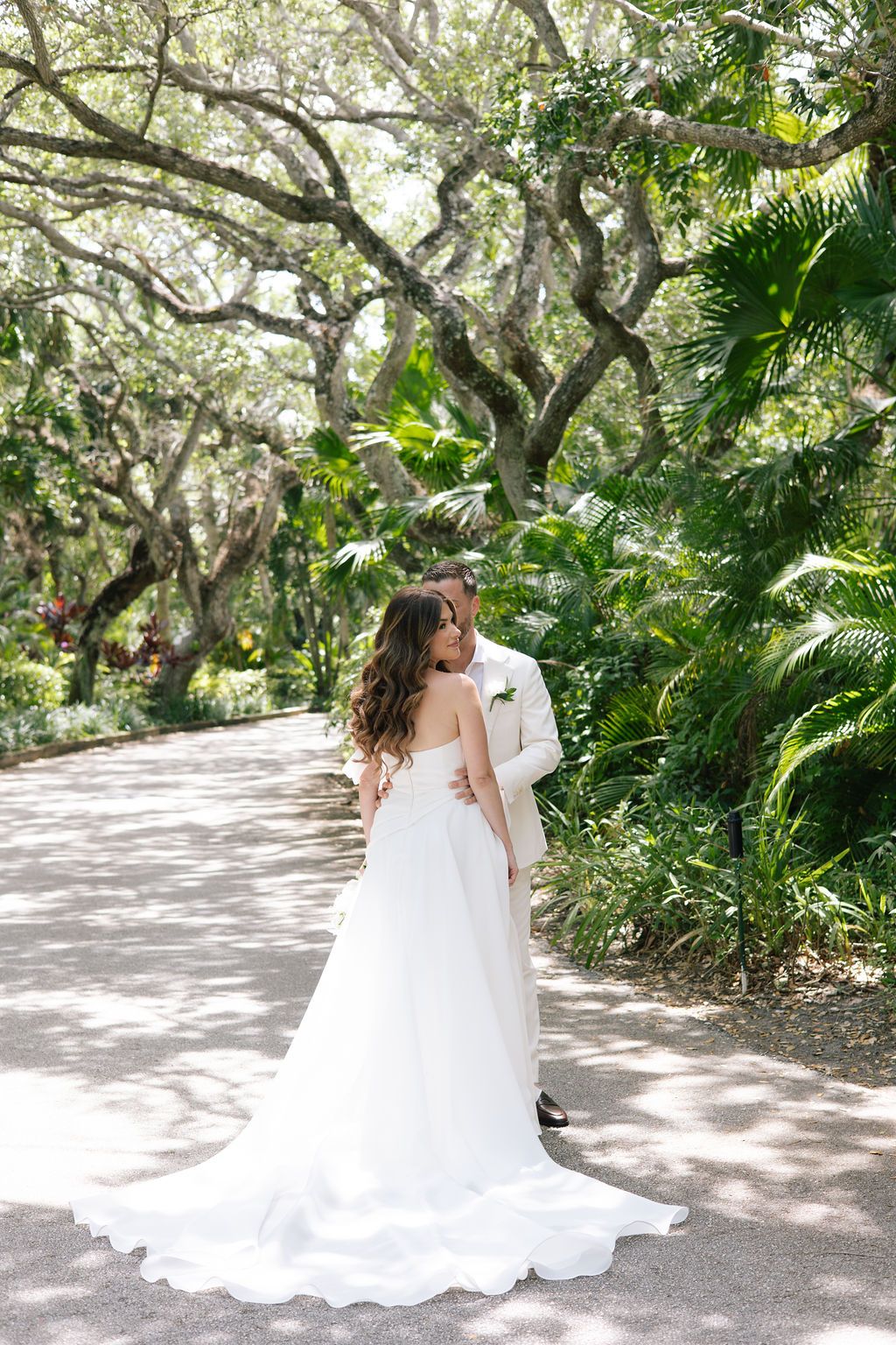 Romantic bridal portraits taken on a winding garden path with overhanging oak trees.