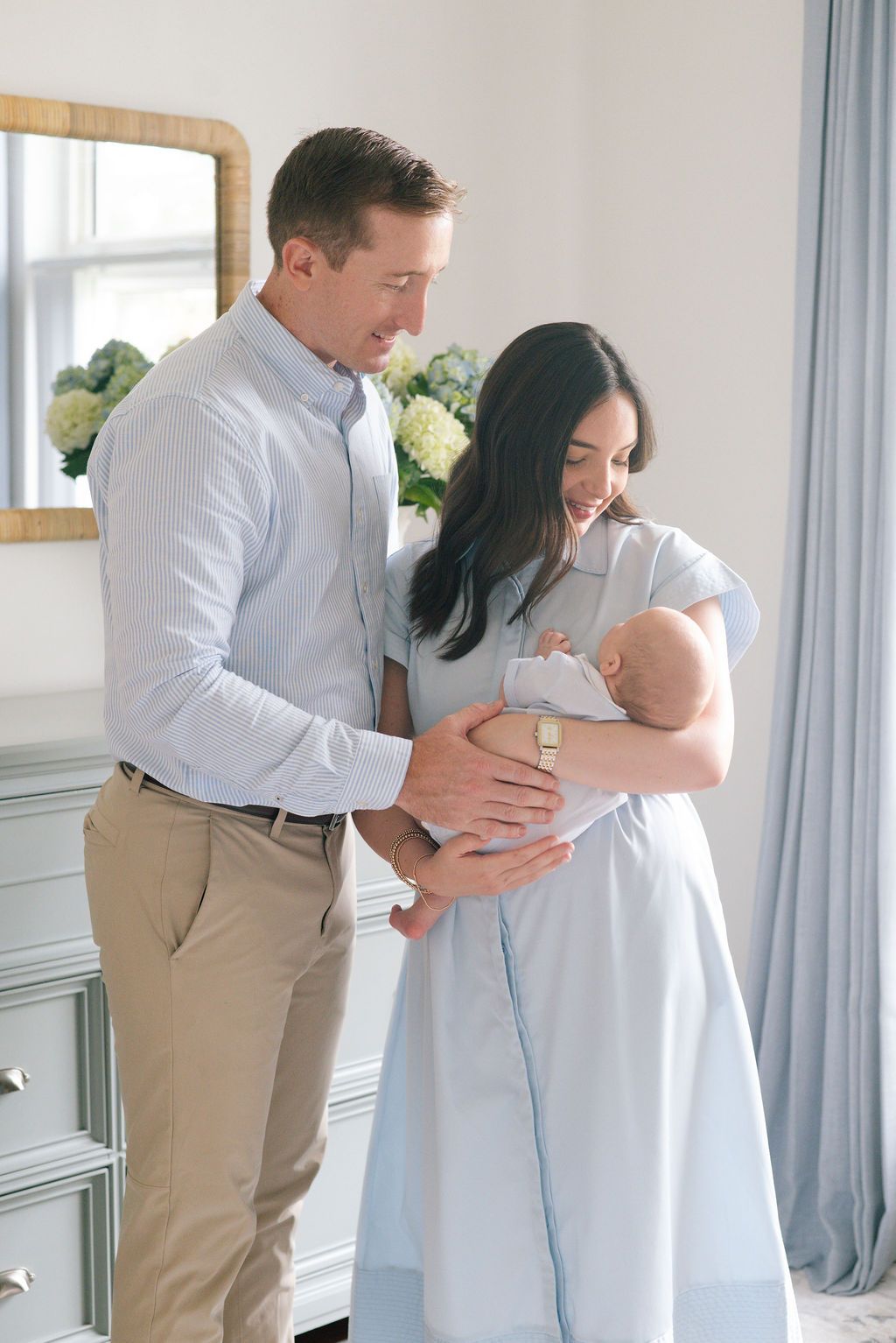Family portrait series in a light-filled nursery with modern decor.