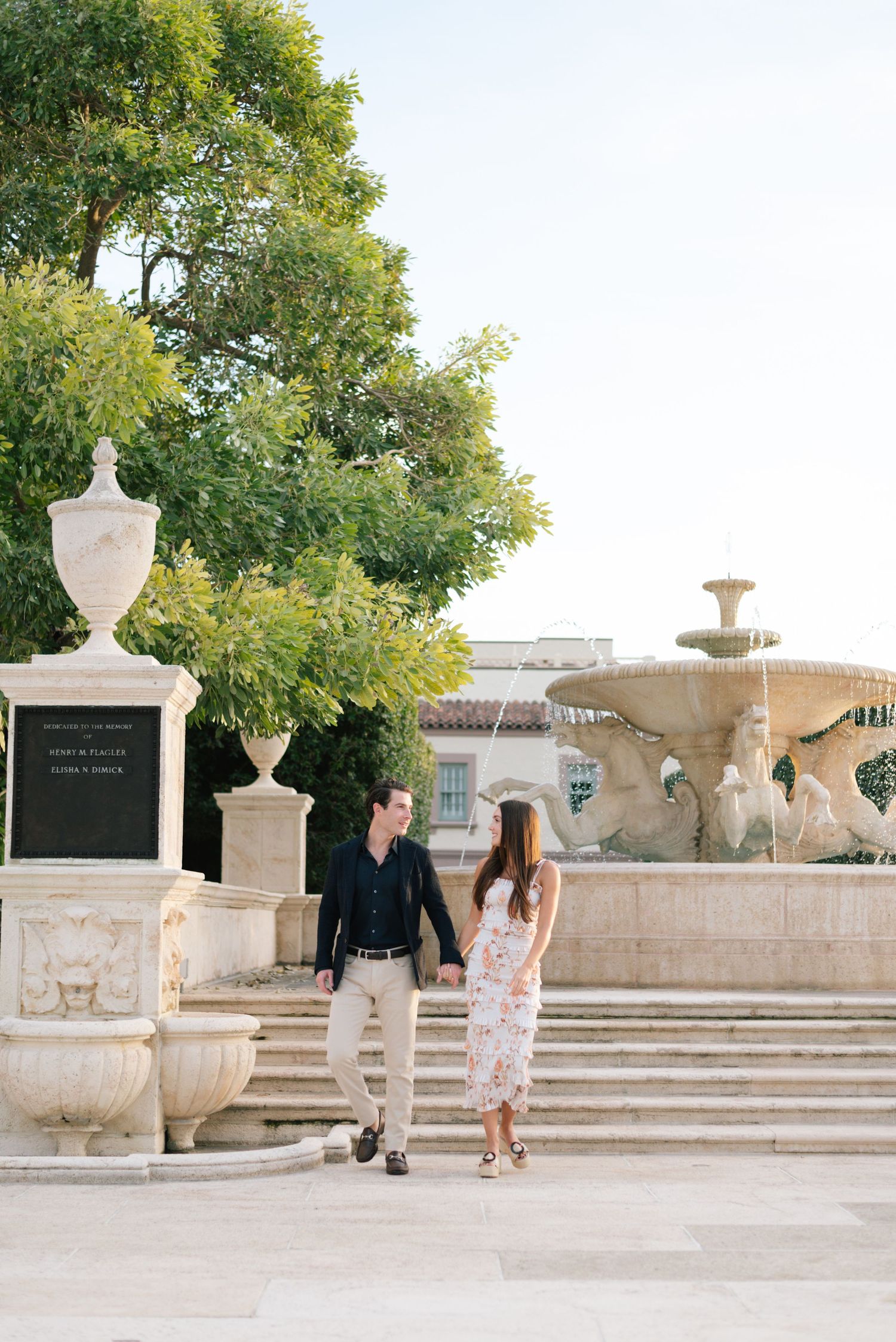 A romantic engagement photoshoot sequence at a classical stone terrace with decorative urns and steps.