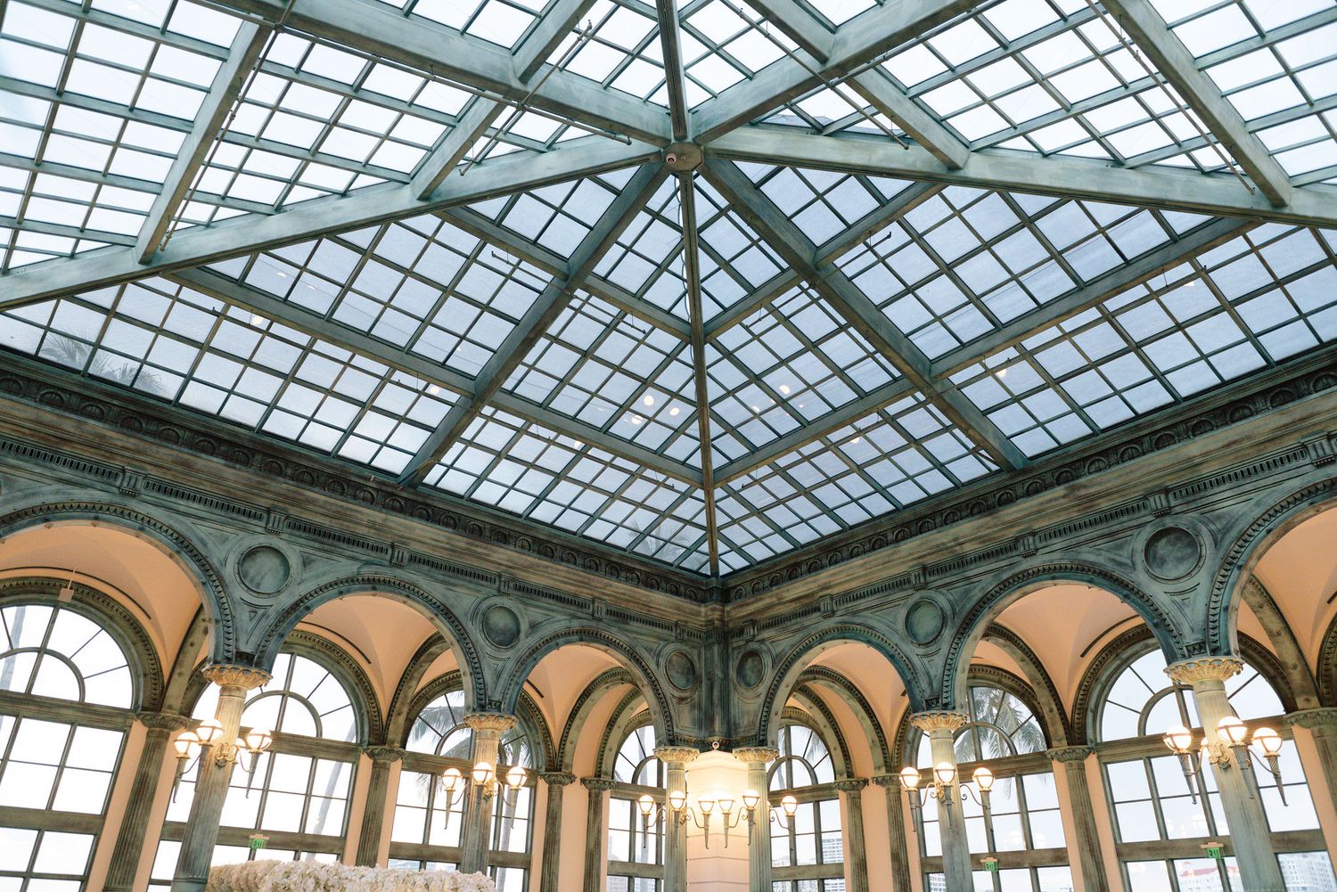 Geometric glass ceiling detail of elegant ballroom with ornate architectural features.