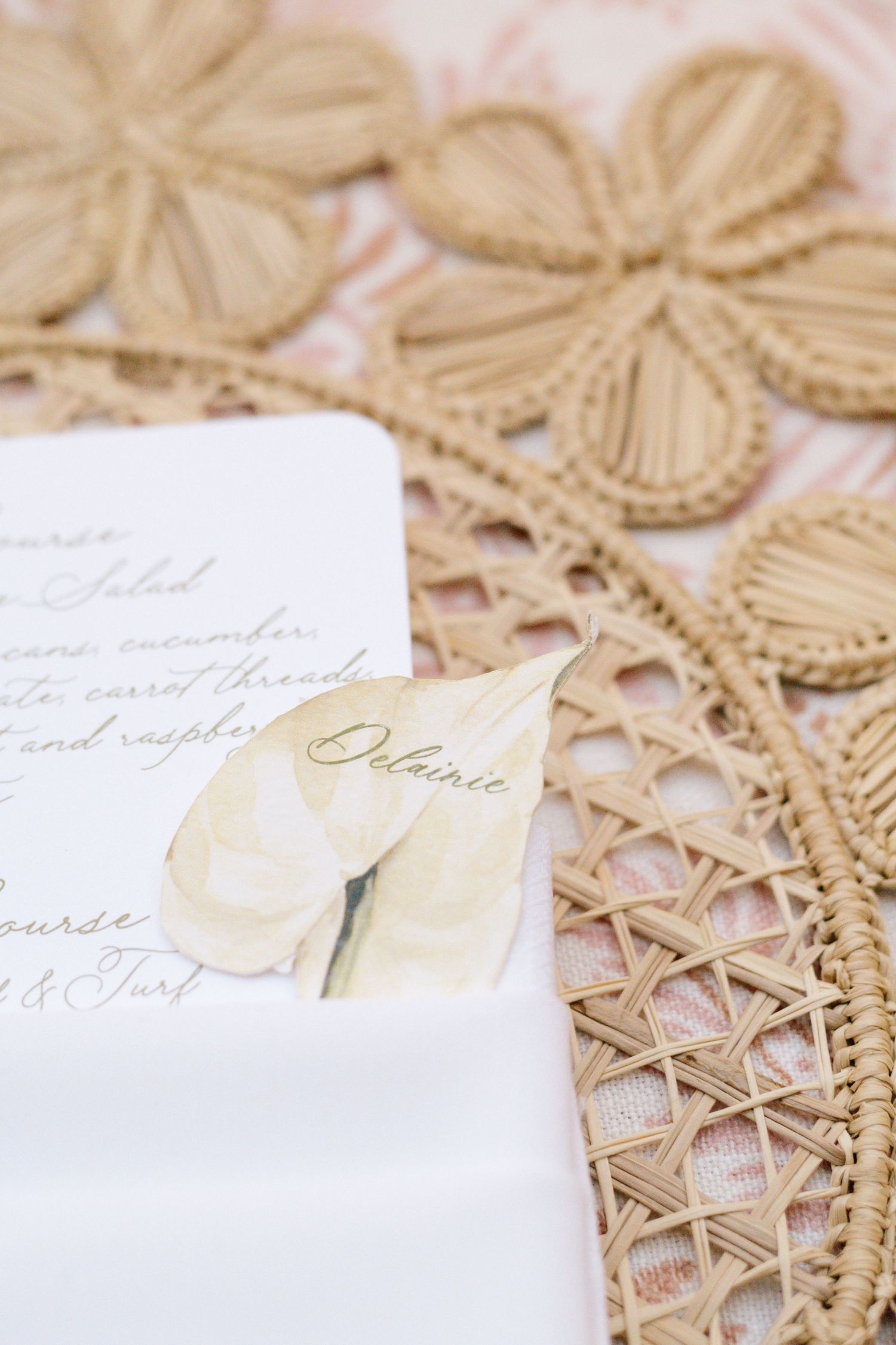 Elegant wedding stationery with calligraphy placed on intricate lace doily.