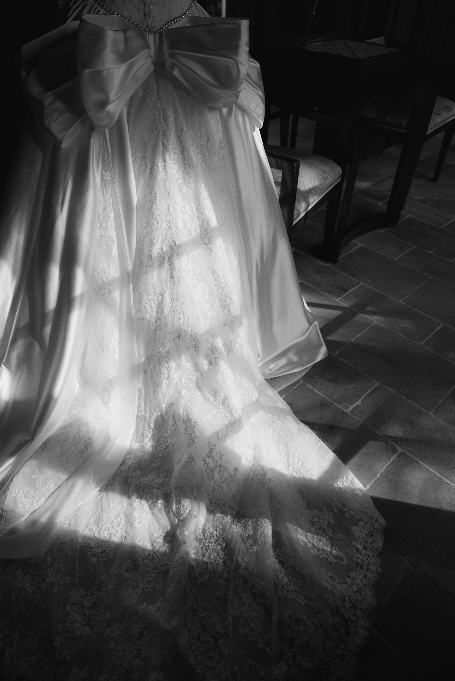 White wedding dress skirt illuminated in dramatic black and white lighting.