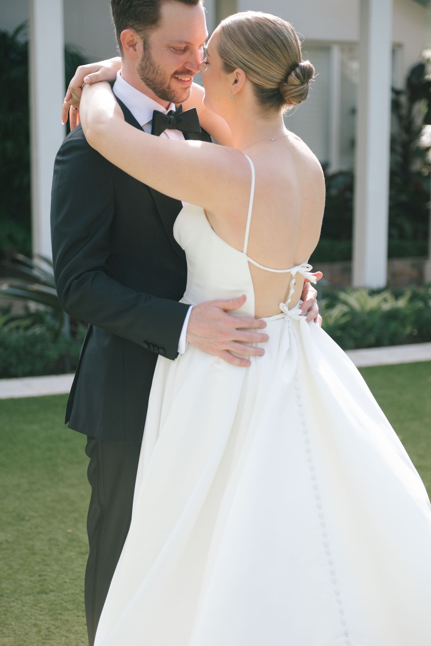 Intimate moment between newlyweds embracing during their outdoor wedding photoshoot.