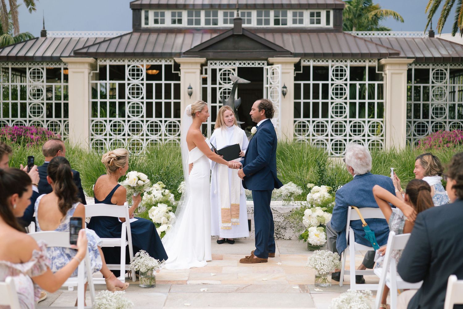 Wedding guests gathered on a patio during an outdoor celebration.