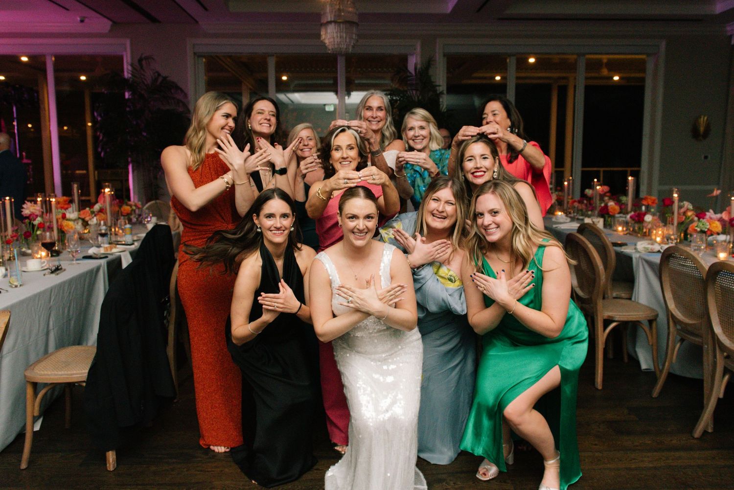Wedding reception celebration with guests dancing and enjoying festivities in an elegant indoor venue.