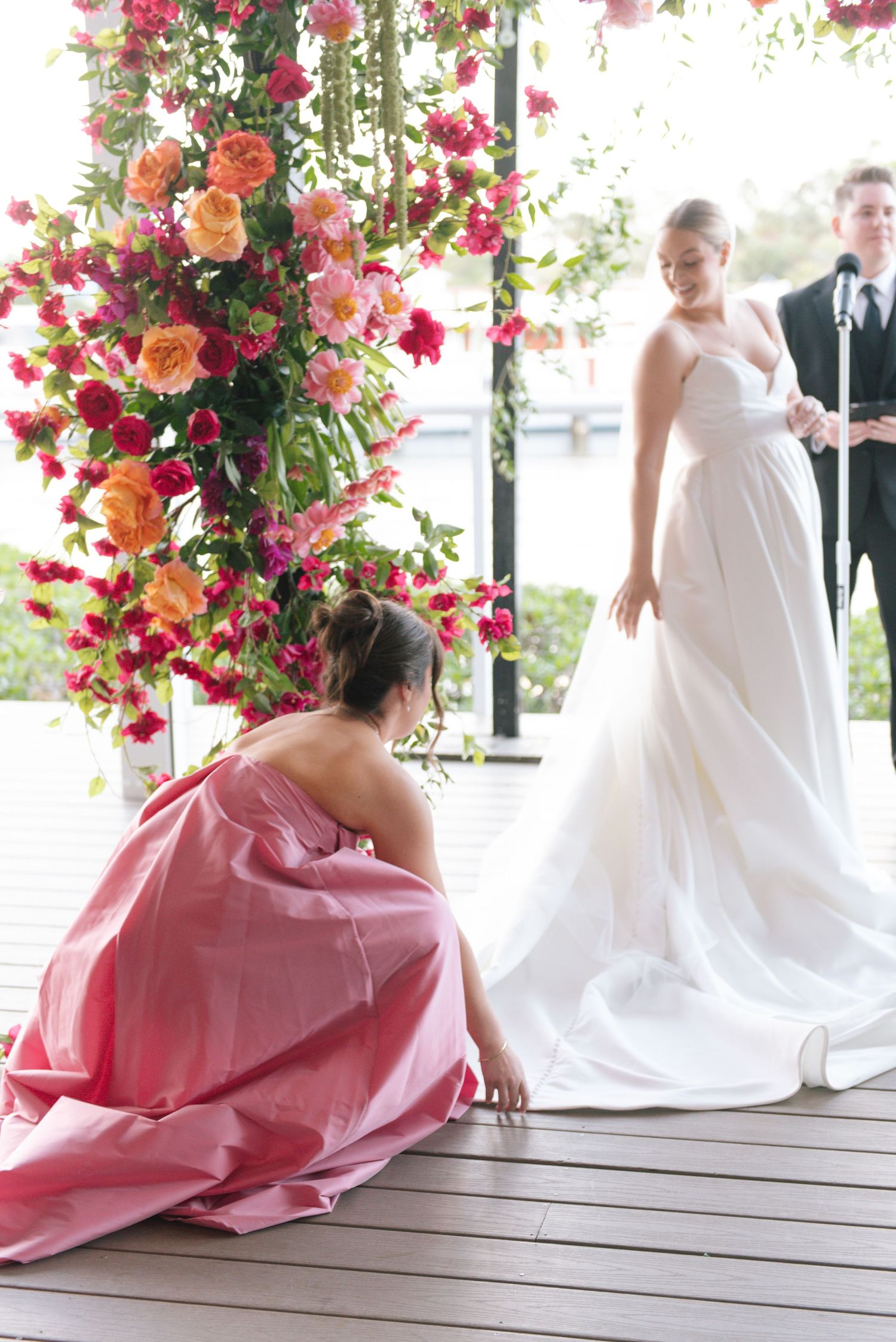 Artistic wedding photos with flowing white gown and pink details against a backdrop of climbing roses.