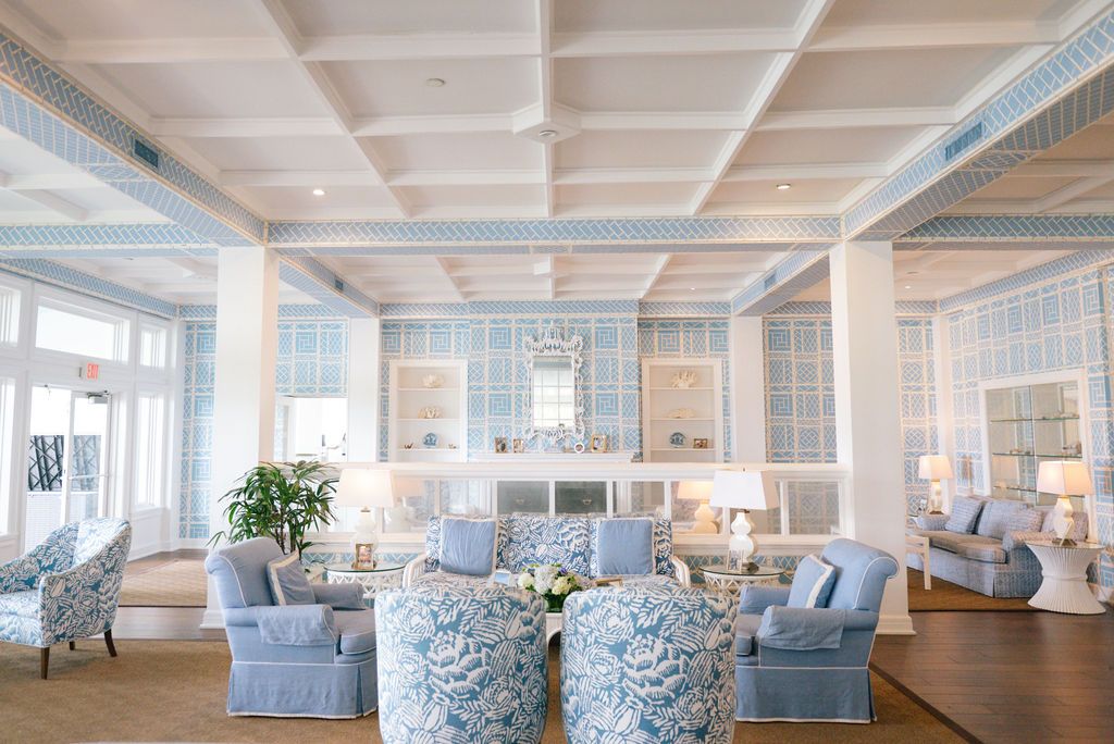 Bright interior space with blue and white coastal decor and coffered ceiling.