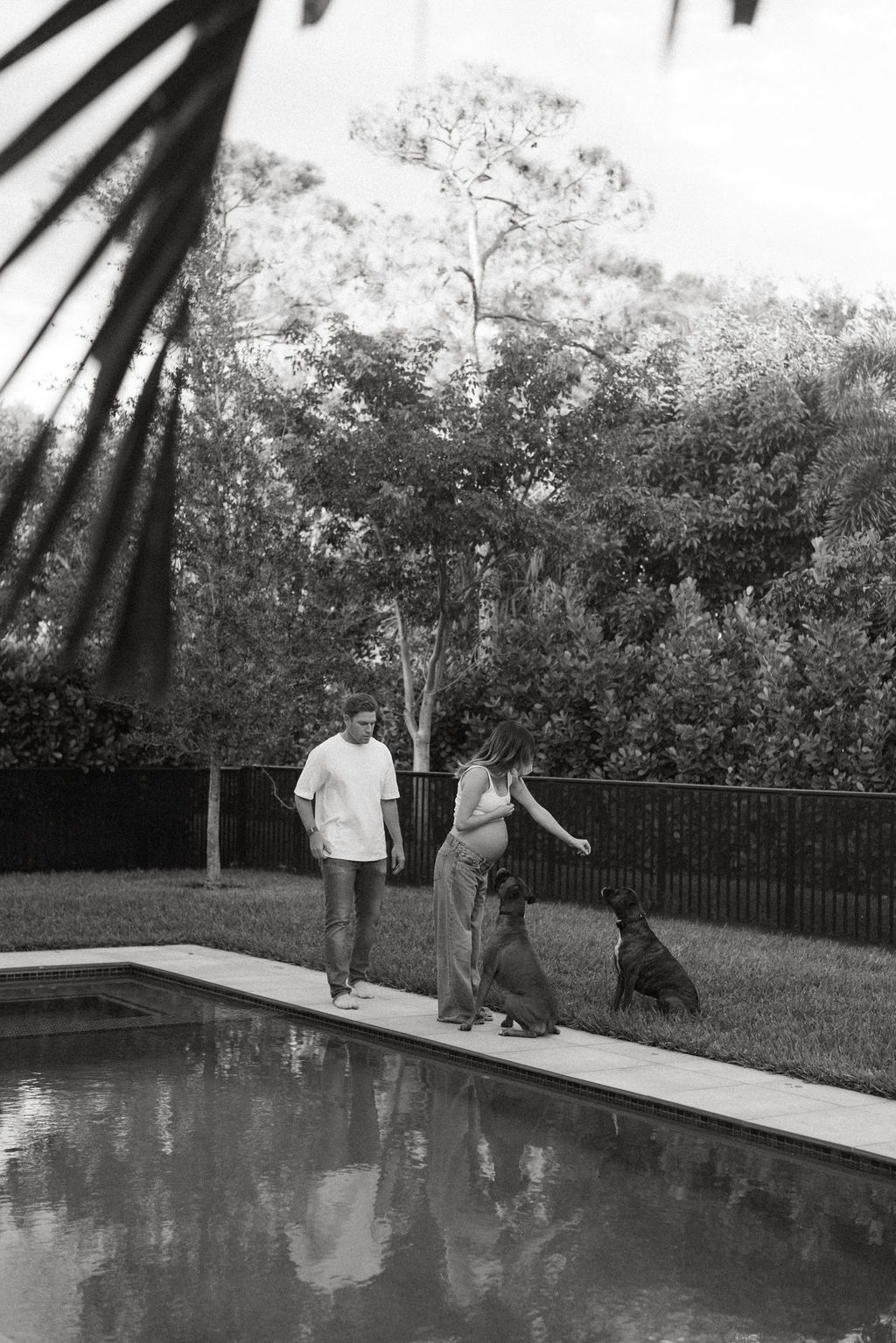 A sequence of black and white photos showing two people by a swimming pool.