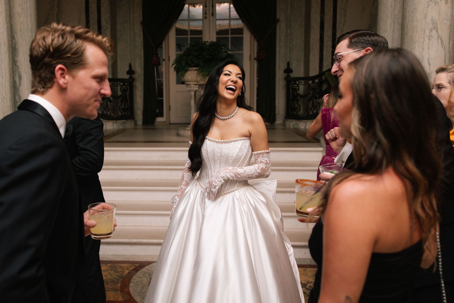 Joyful wedding celebration moment in elegant venue with classical architecture.