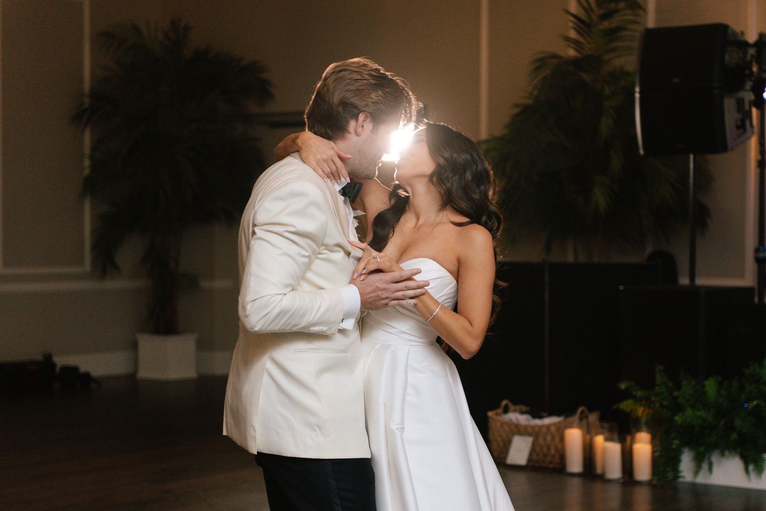 Newlyweds share an intimate moment during their wedding reception dance in an elegant venue.
