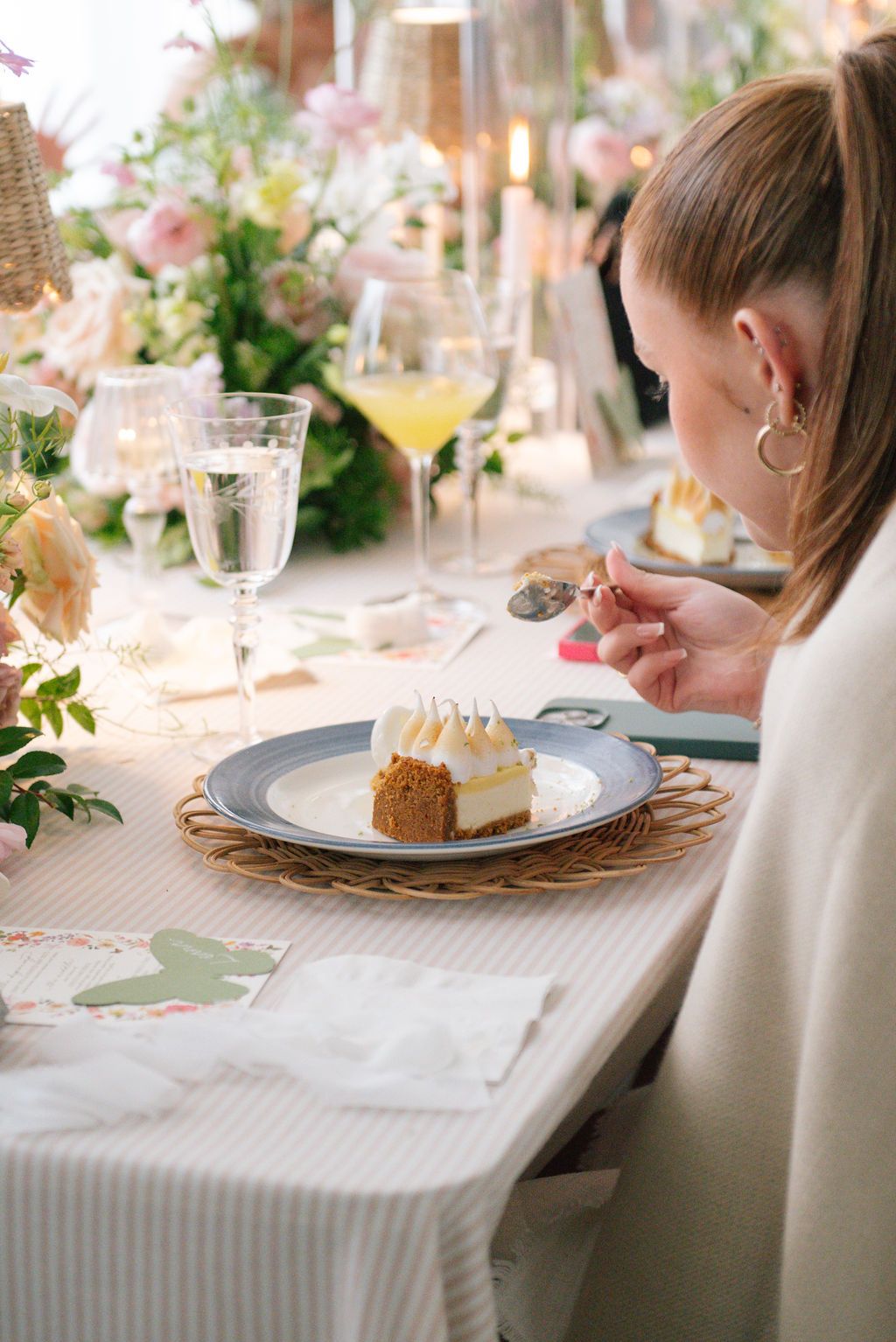 Elegant table setting with dessert plates and white linens at a formal event.
