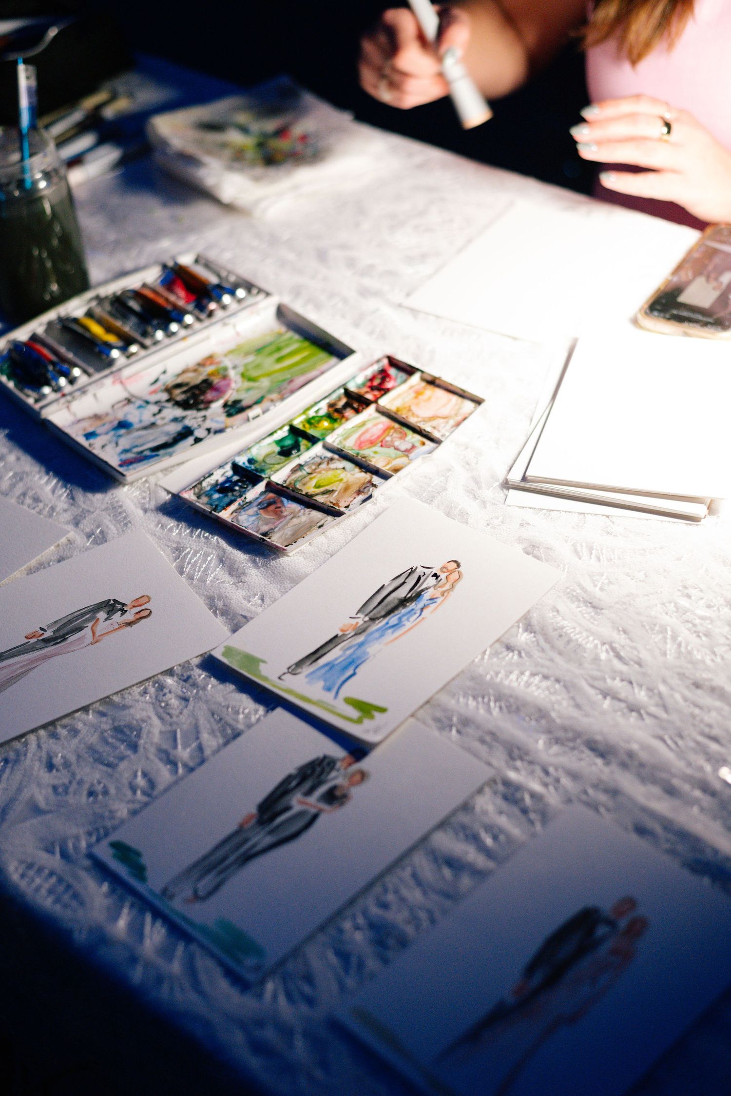 Wedding guest book or photo album display on white textured tablecloth.