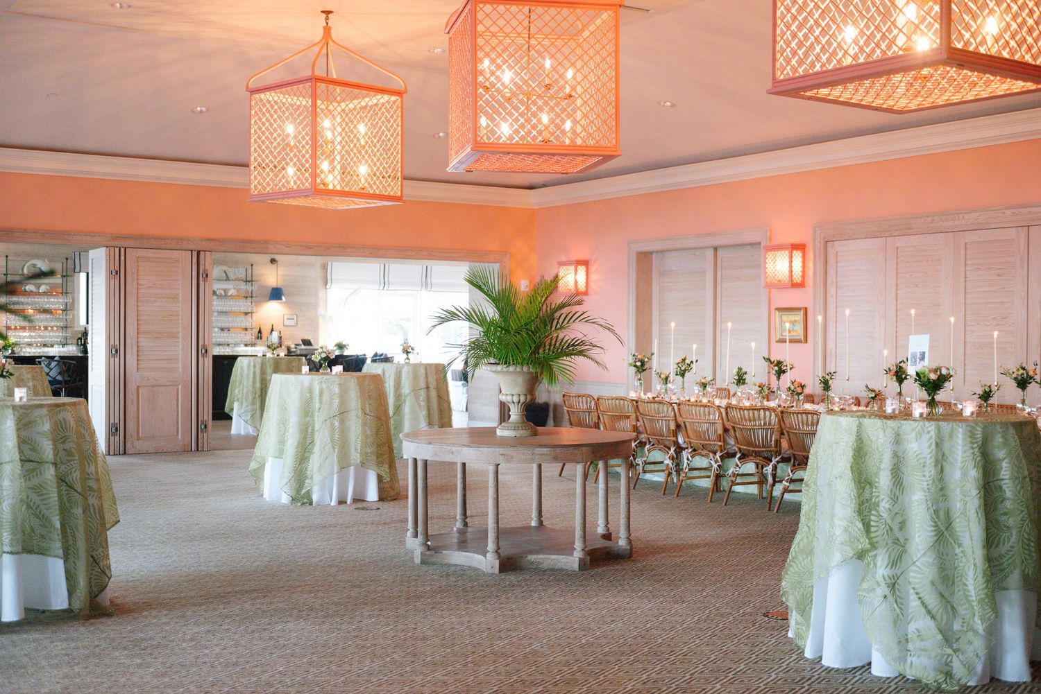 Spacious reception venue with lattice pendant lighting and coastal decor.