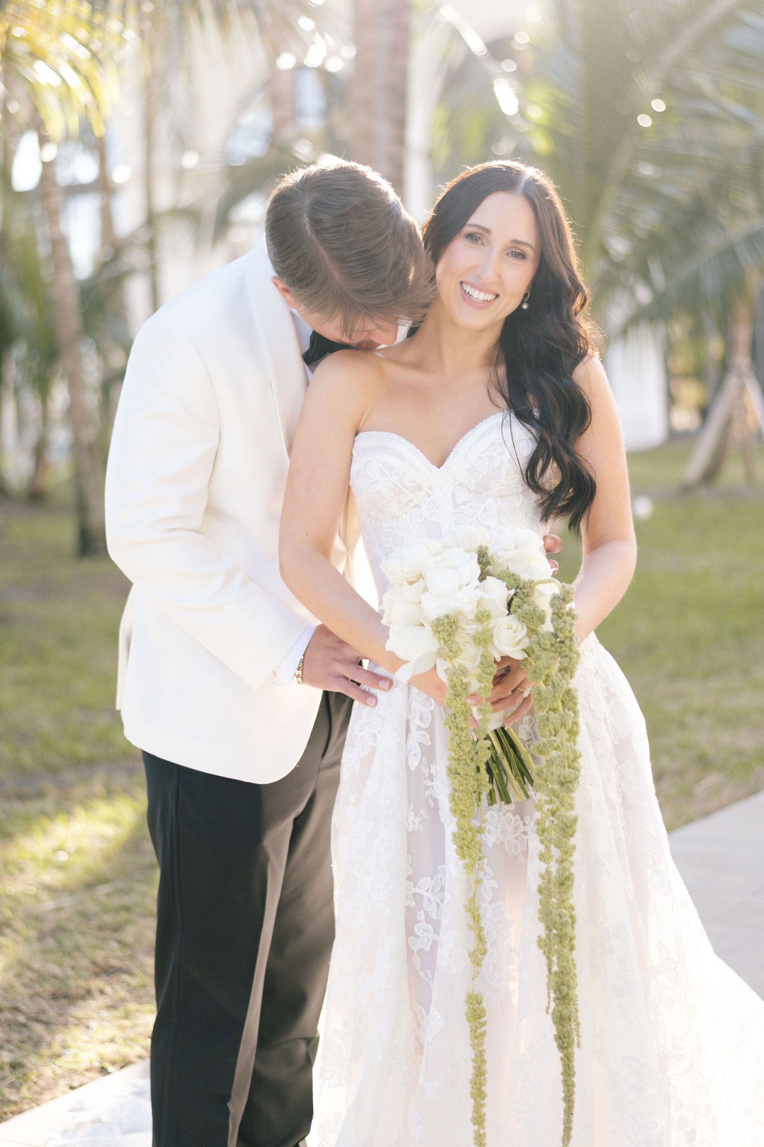 Wedding photography sequence with flowing white dress and tropical garden setting.