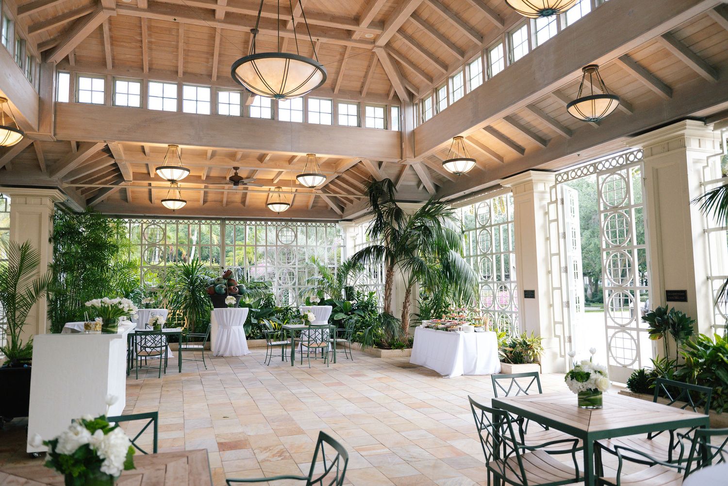 Spacious indoor venue with vaulted wooden ceiling and large windows letting in natural light.