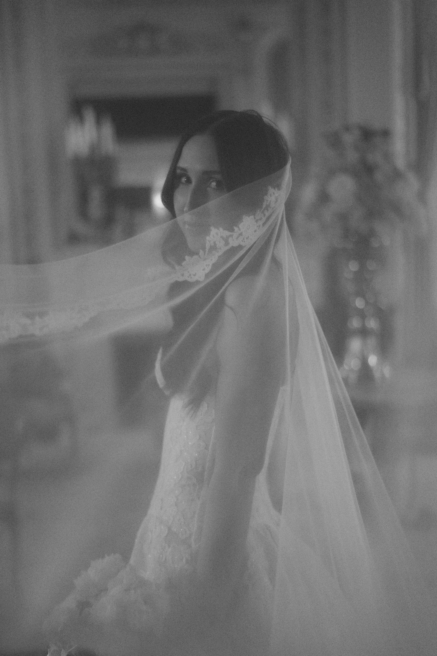 Ethereal black and white bridal portraits with flowing veil.