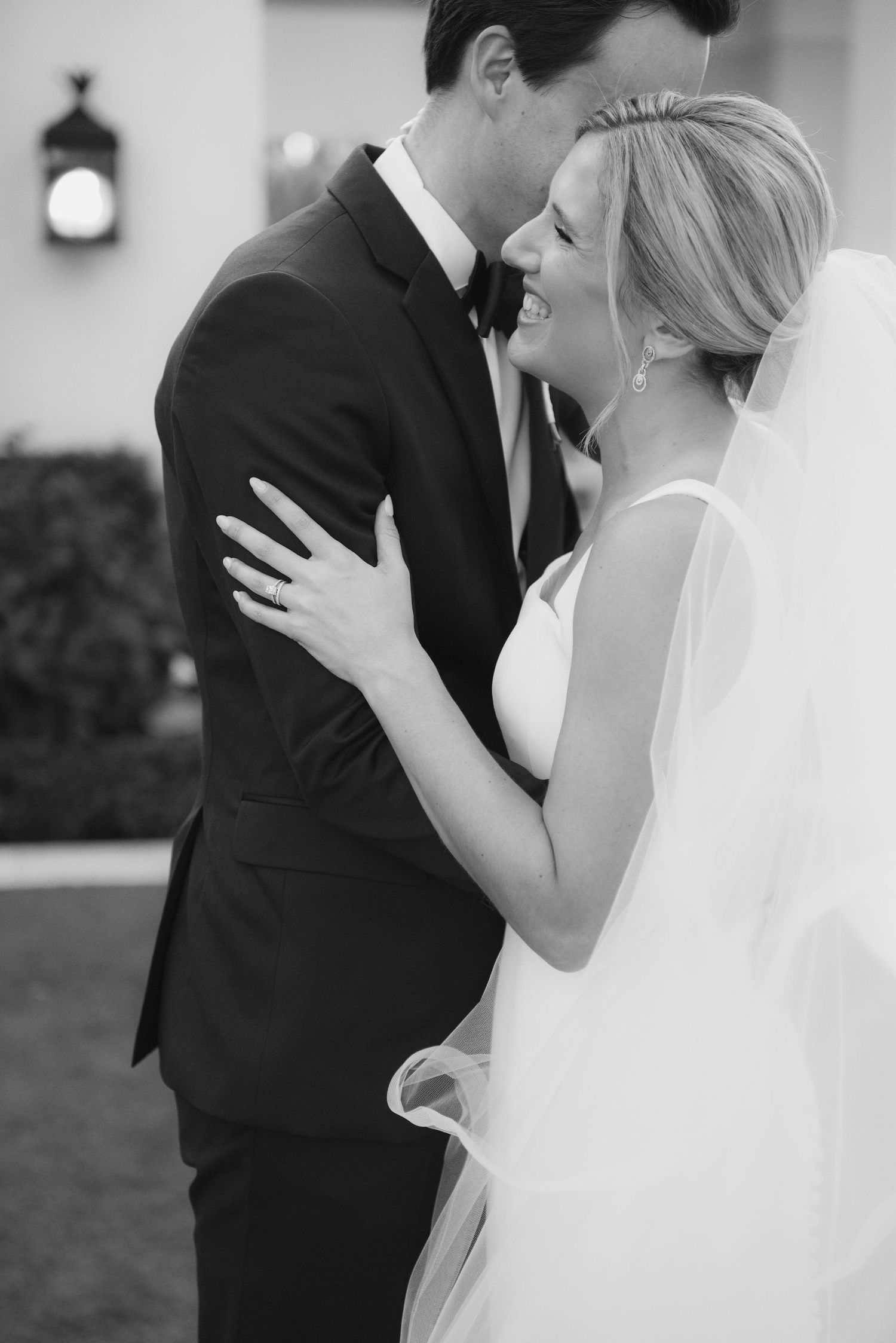 Intimate black and white wedding portraits showing tender moments between newlyweds.