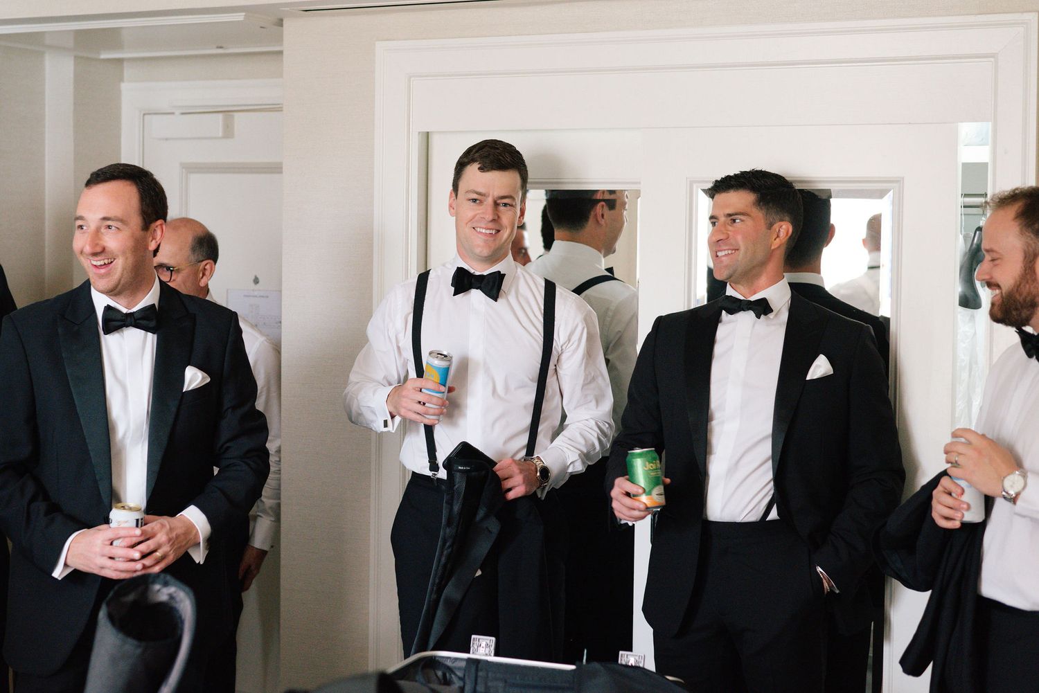 A sequence of black and white photos showing people in formal attire holding drinks and conversing at an elegant event.