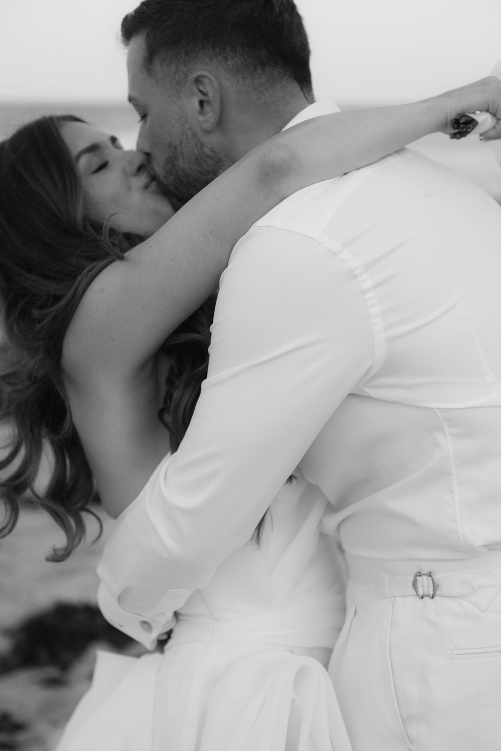 Intimate black and white wedding portraits showing tender embrace.