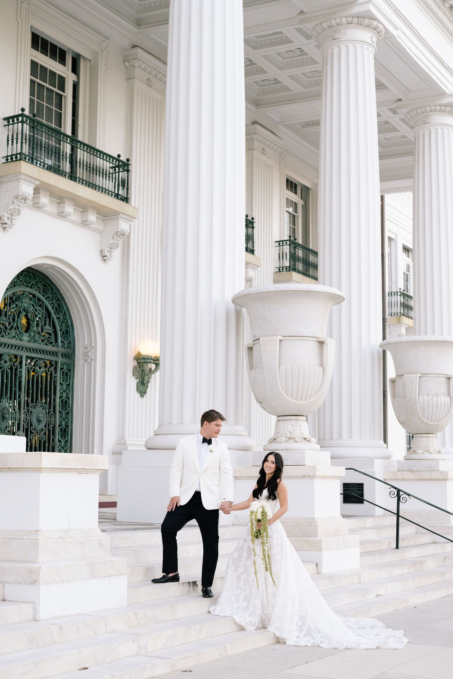 Elegant wedding photo series at a white columned venue showing romantic poses between couple.