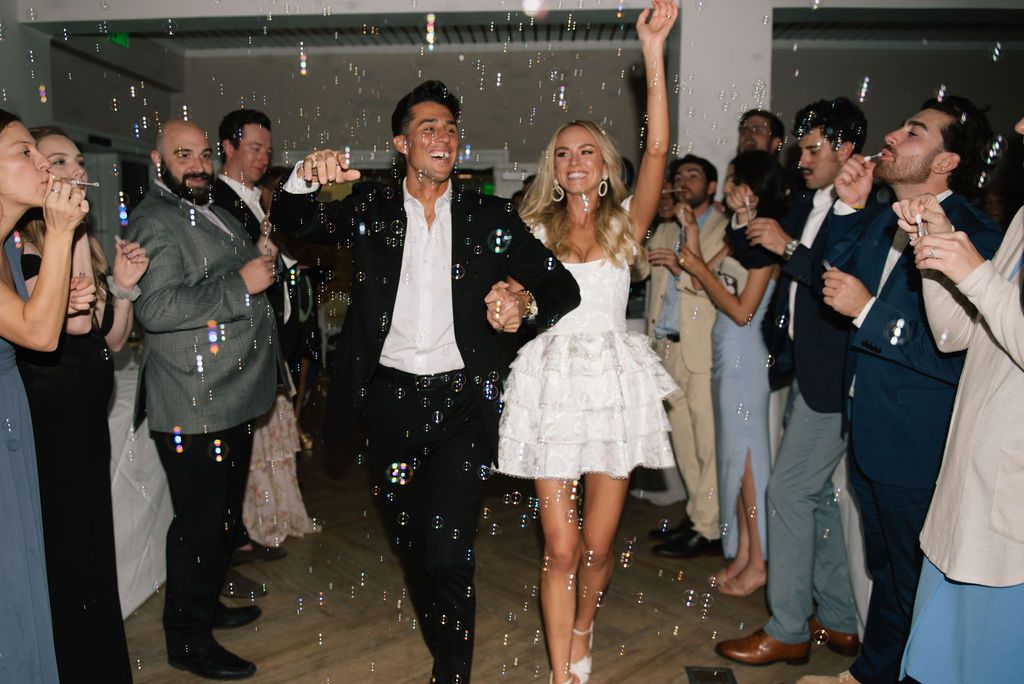 Wedding guests form a line on the dance floor during a celebration.