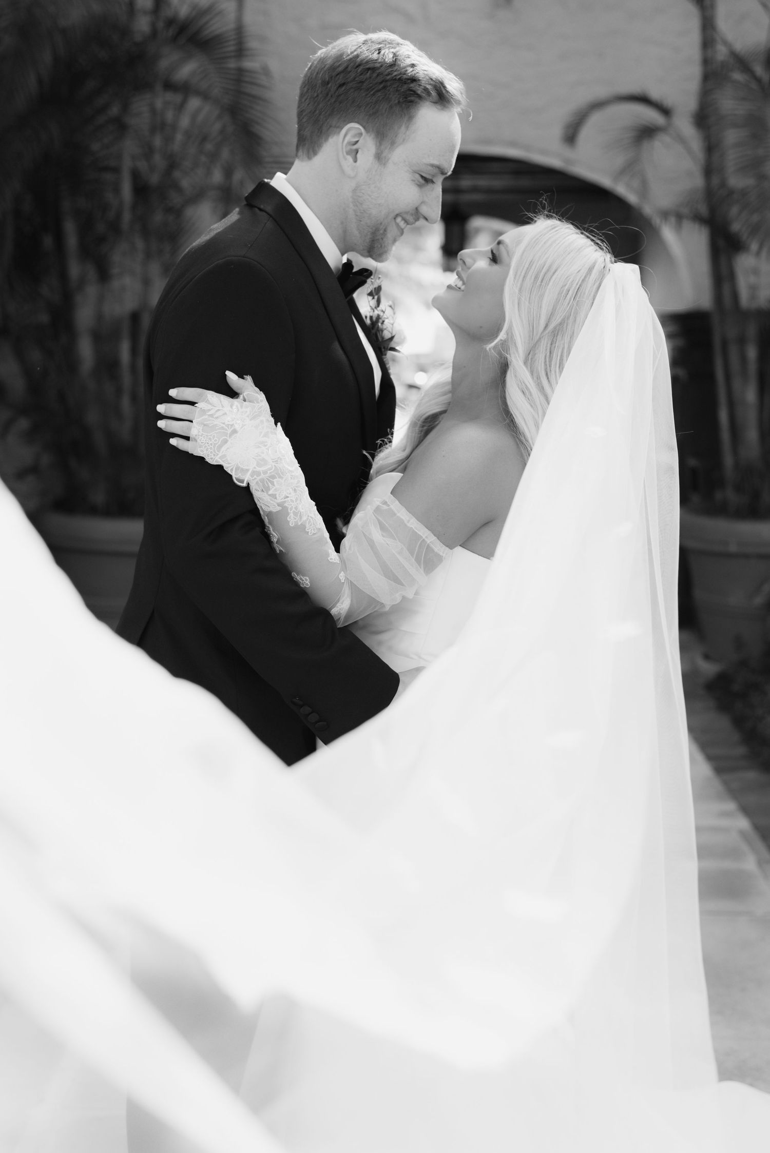 A romantic black and white wedding photo series showing tender moments between a bride and groom during their first dance.