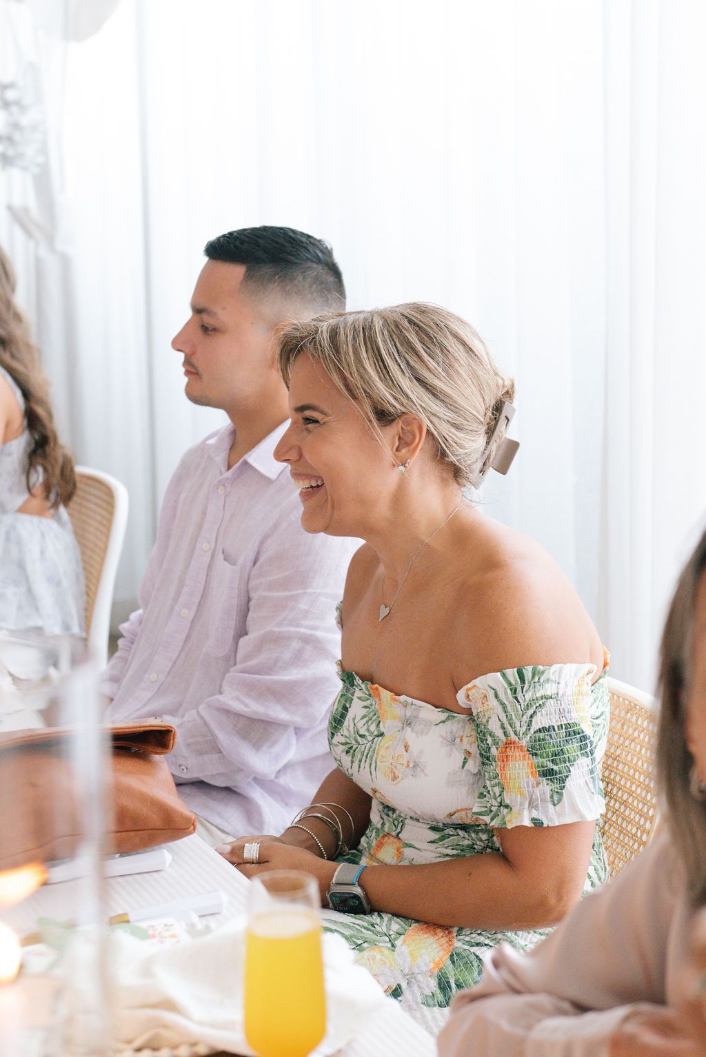 Guests enjoying conversation and orange juice at an elegant brunch gathering.