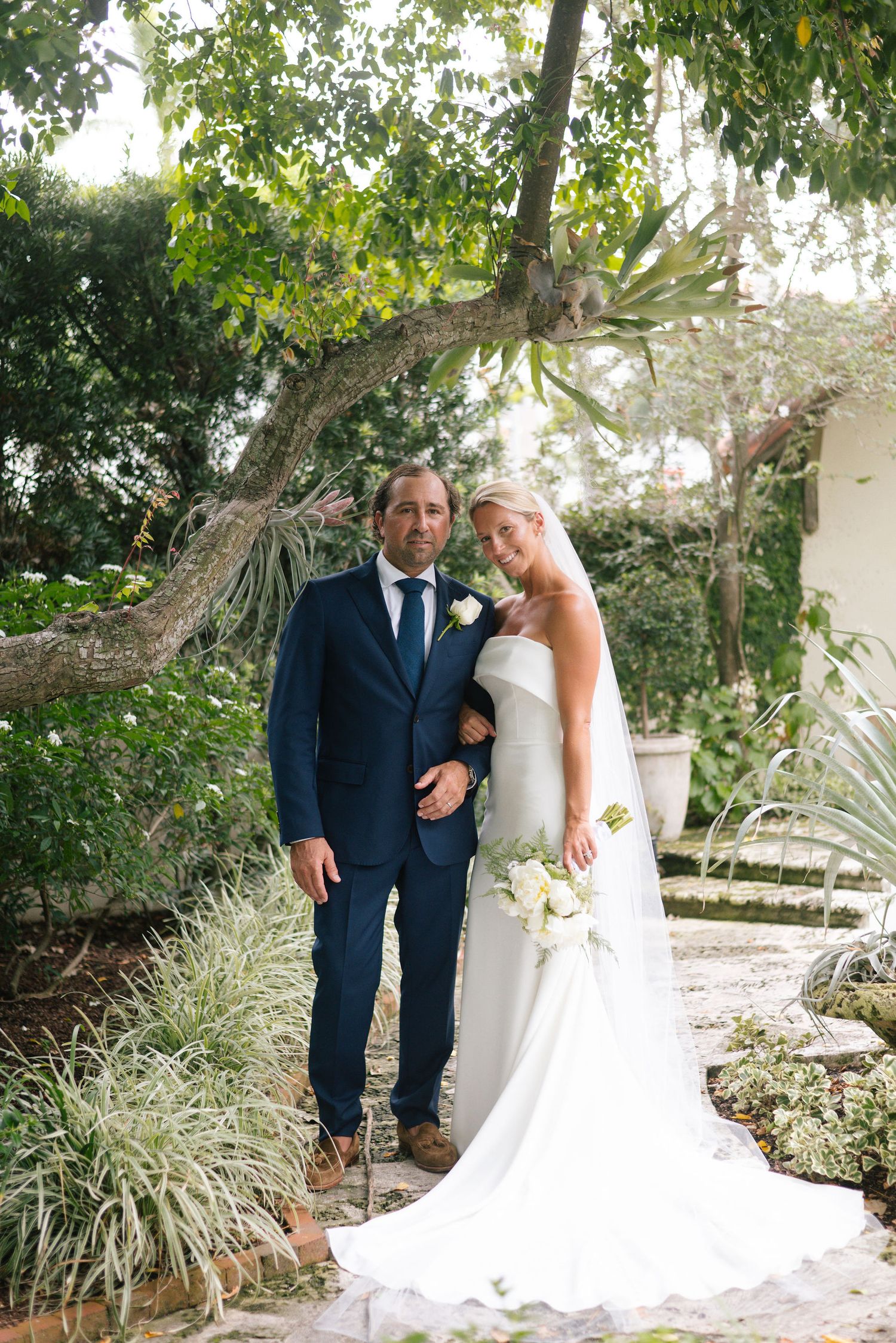 Romantic garden wedding portraits with ornamental grasses and tropical landscaping.