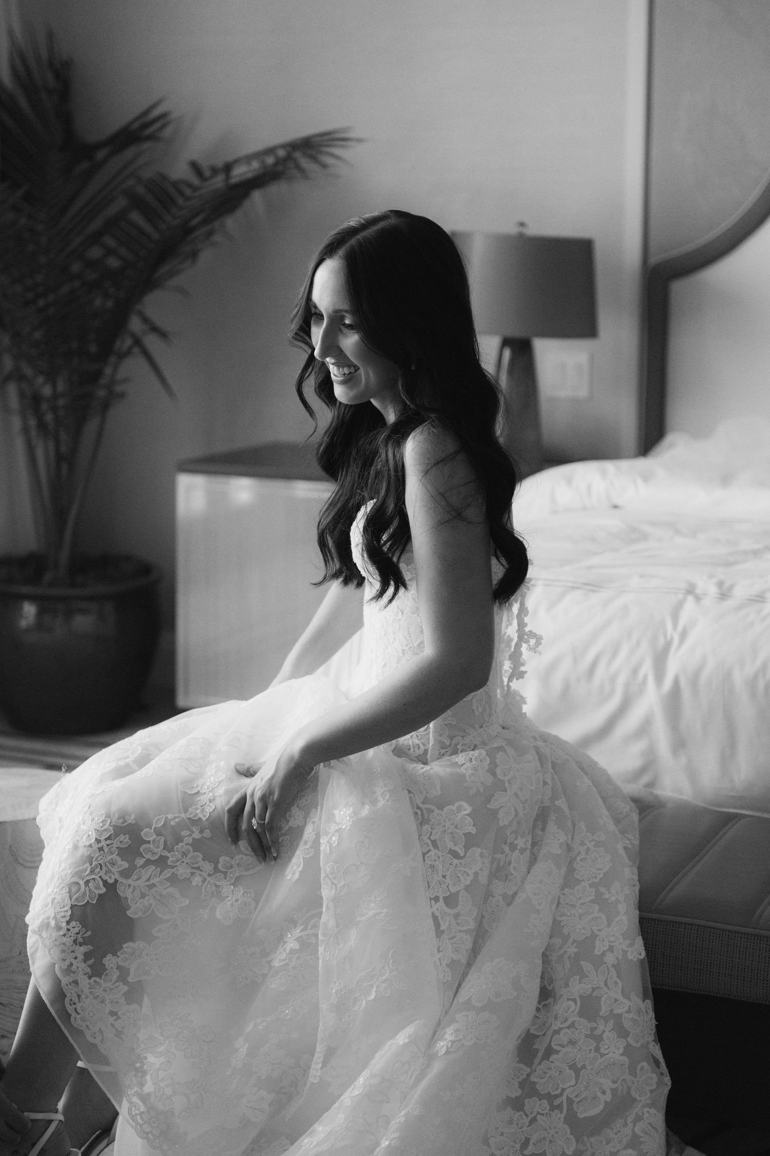 Black and white portrait of bride in lace wedding dress.