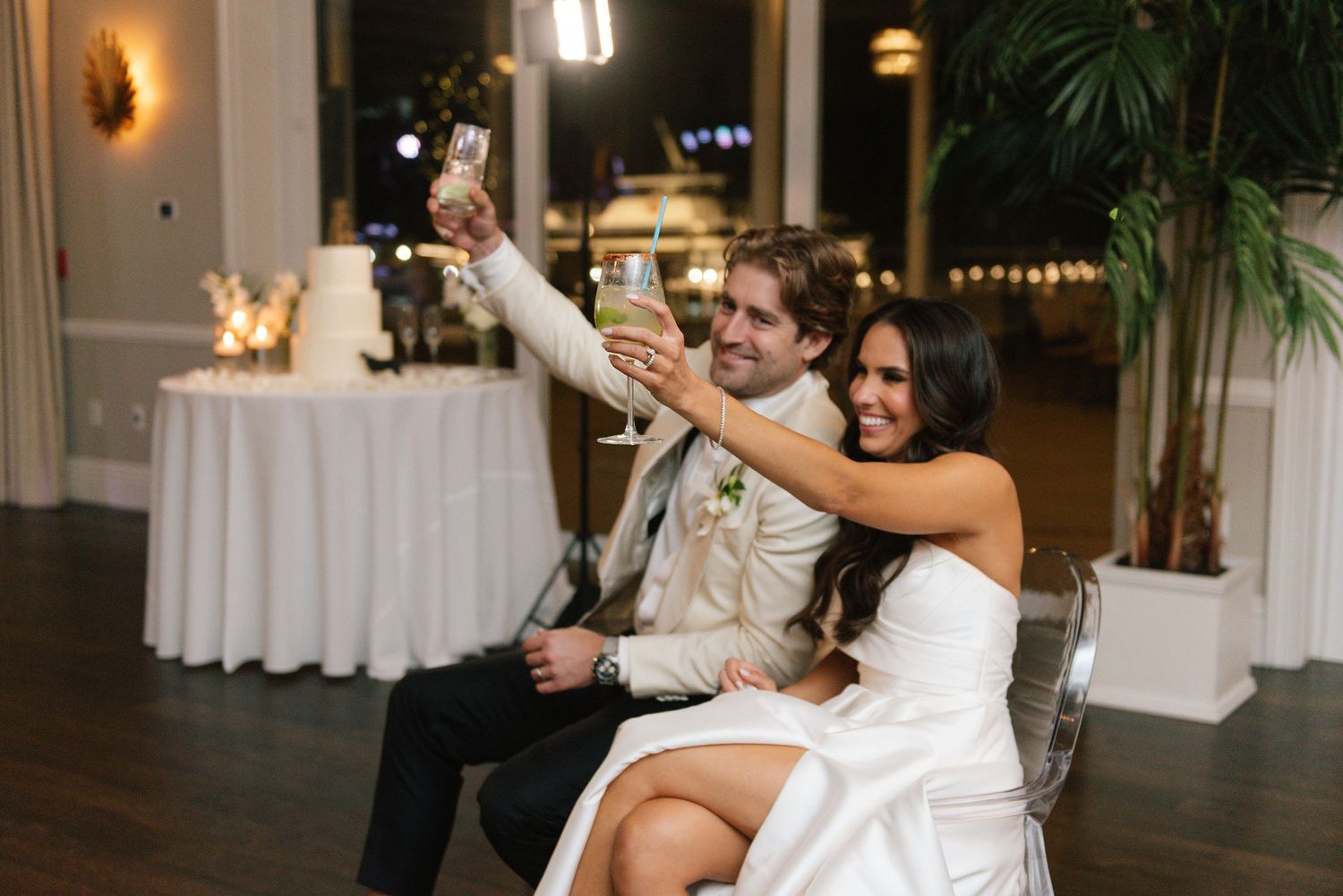 A couple performs a dramatic dance lift during their wedding reception with guests watching.