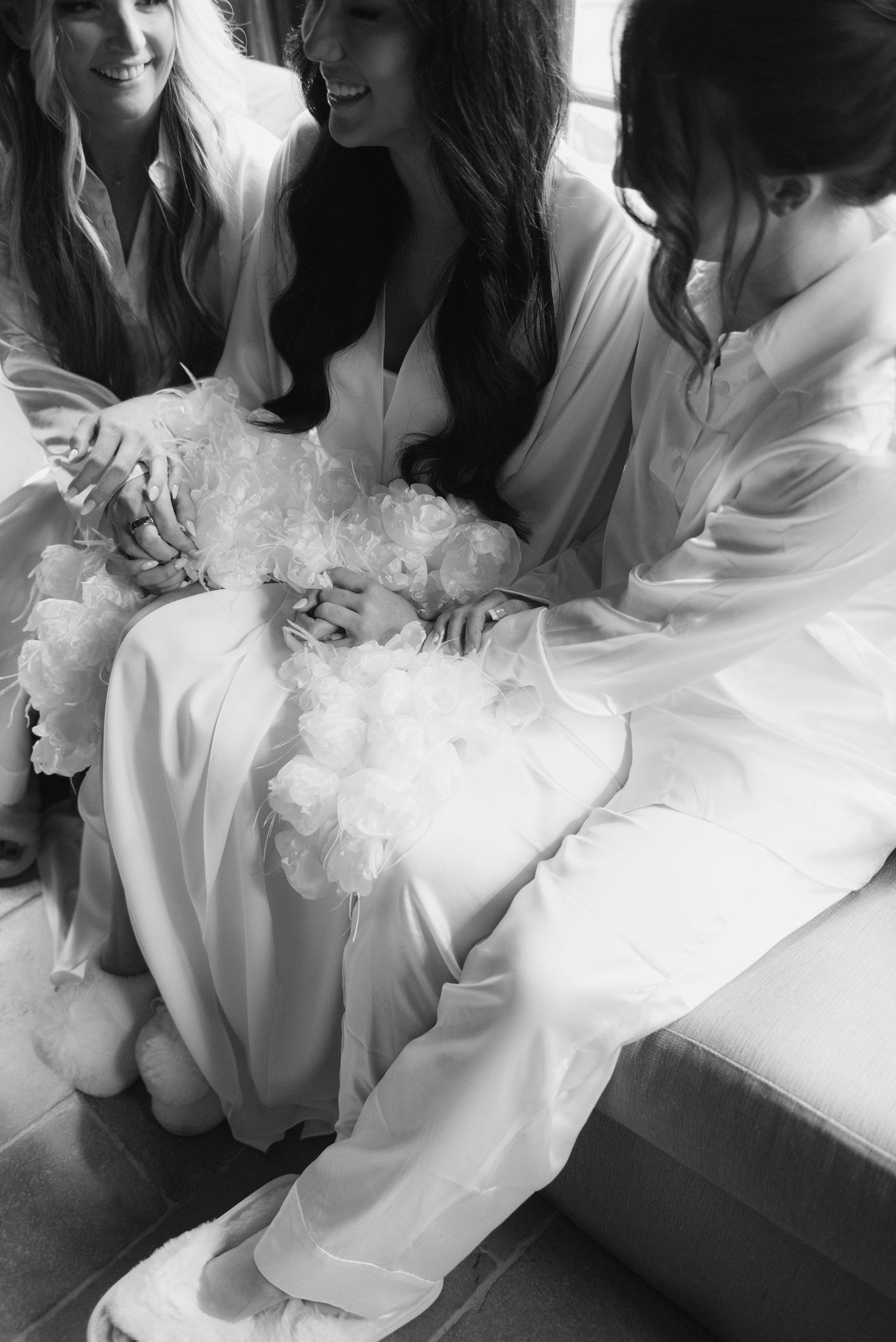 Group wearing white robes gathered together in casual conversation.