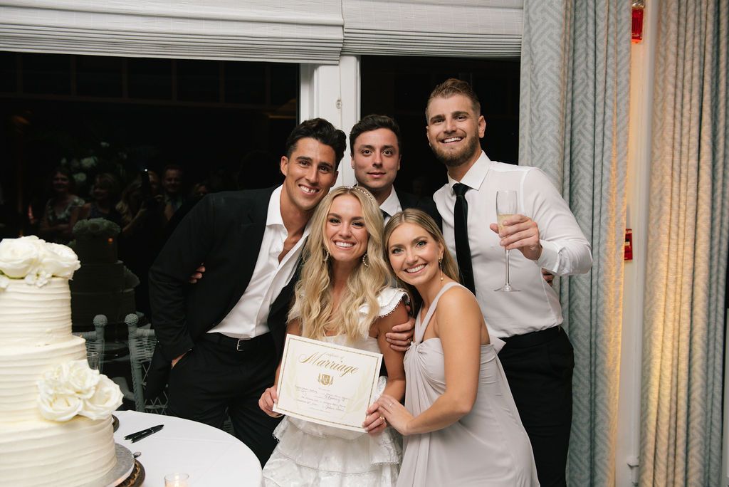 Wedding guests celebrate and pose together during the reception festivities.