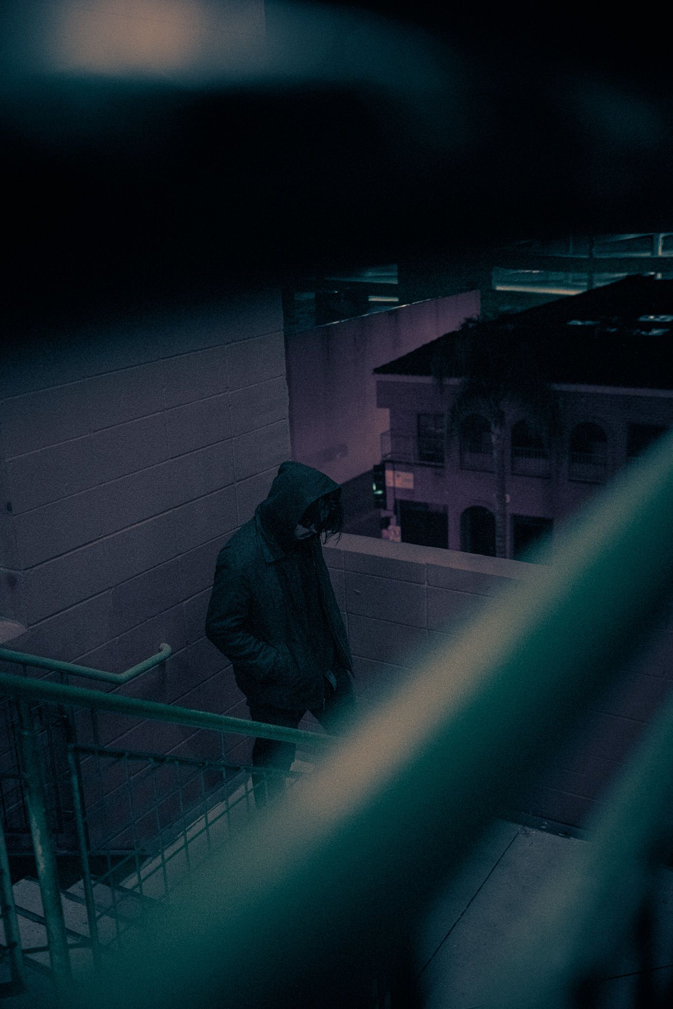 Dark silhouettes in an empty classroom with dramatic lighting.
