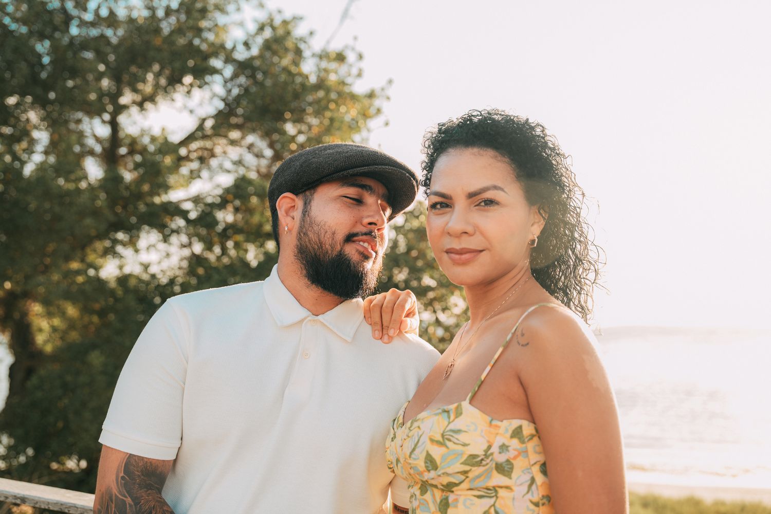 Couple sharing intimate moment outdoors during sunset photo session.