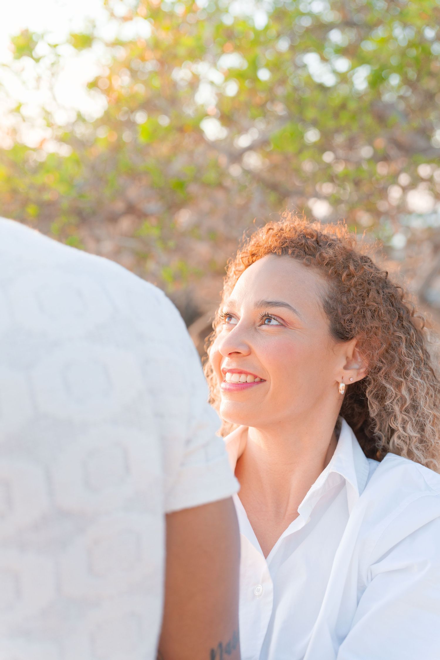 Side profile of person smiling in bright natural sunlight.