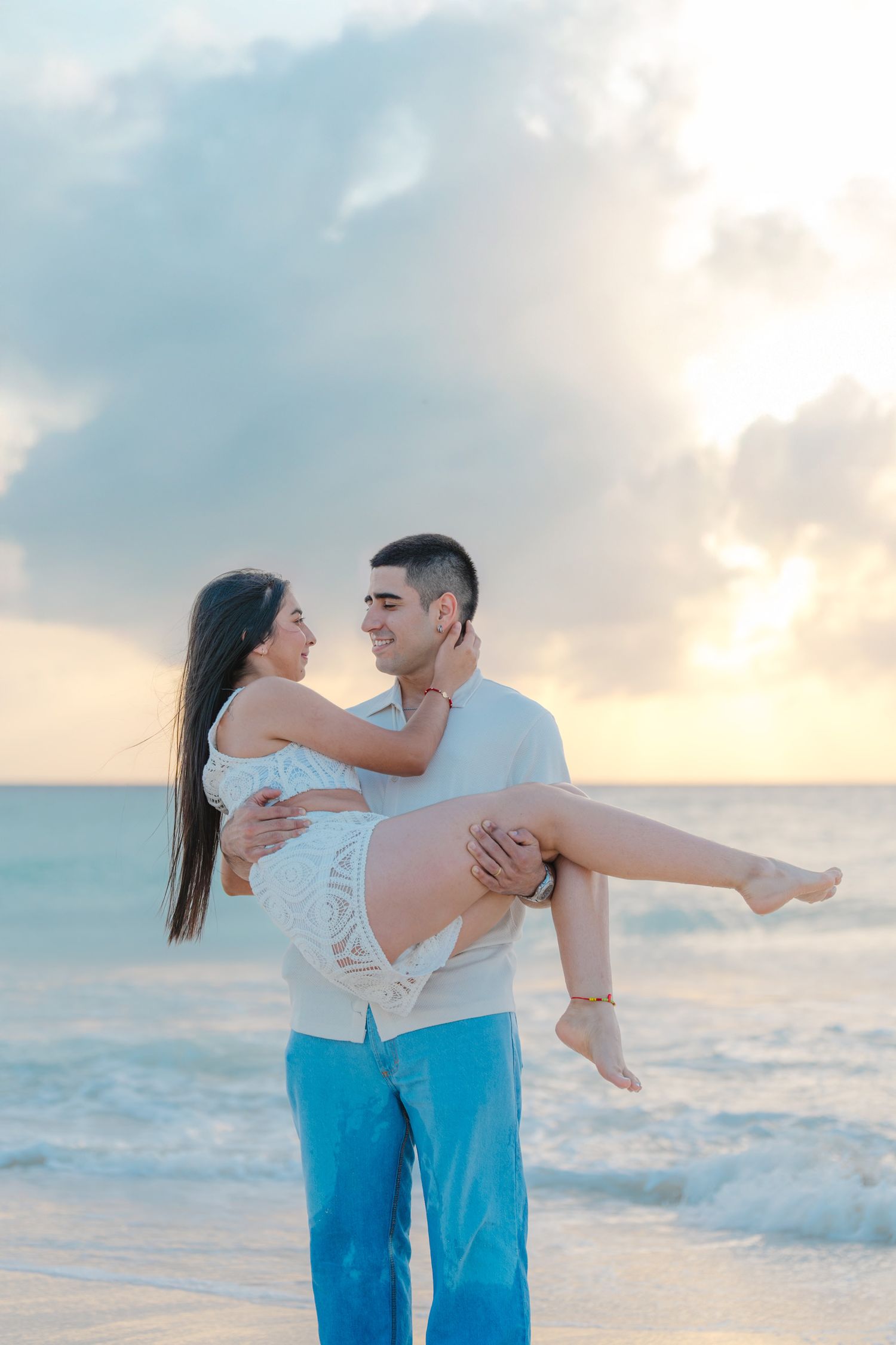 A tender moment captured between a couple on the beach during sunset.