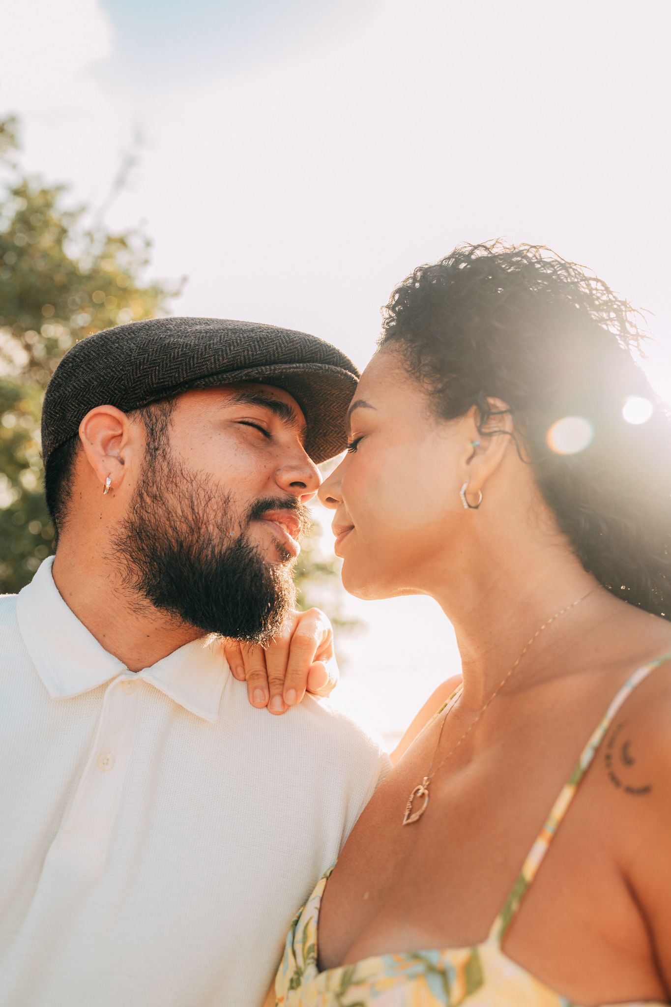 Close-up of couple sharing intimate moment in warm sunlight.
