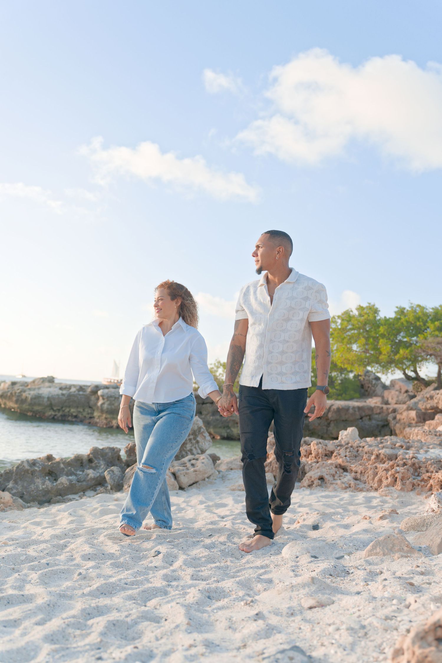 Couple walking together on a sandy beach during sunset with multiple candid shots showing their journey.