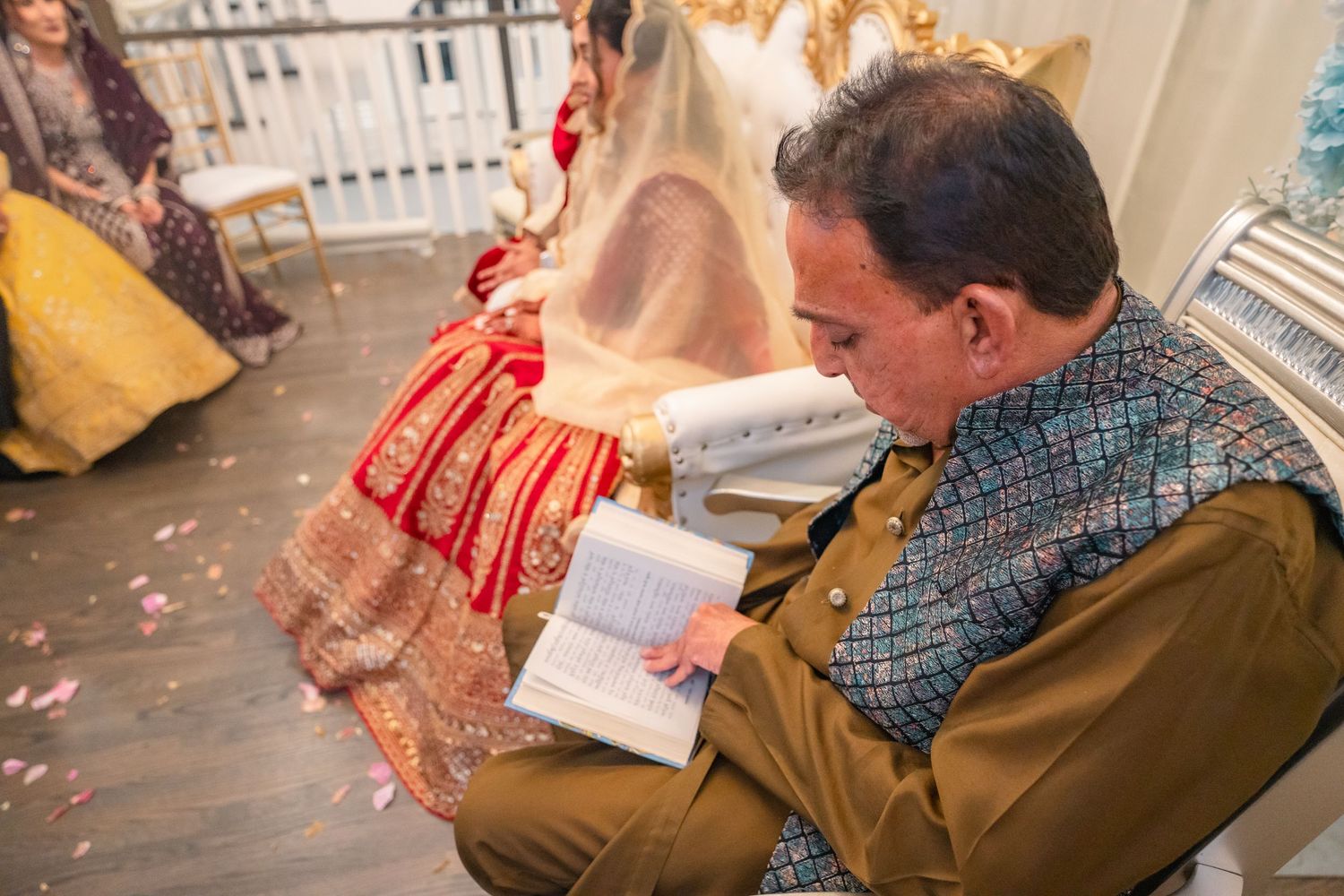 Priest giving wise words infront of couples's family at a traditional wedding